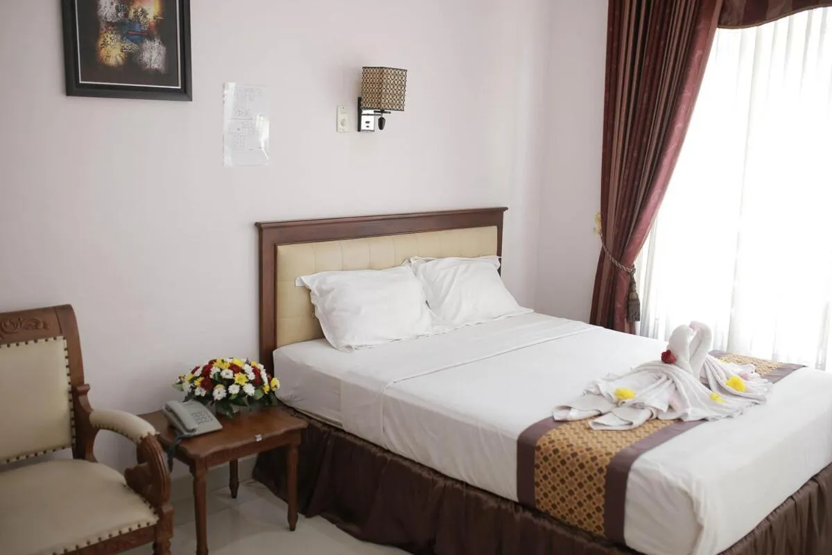 Bed in WISMA KUSUMA HOTEL