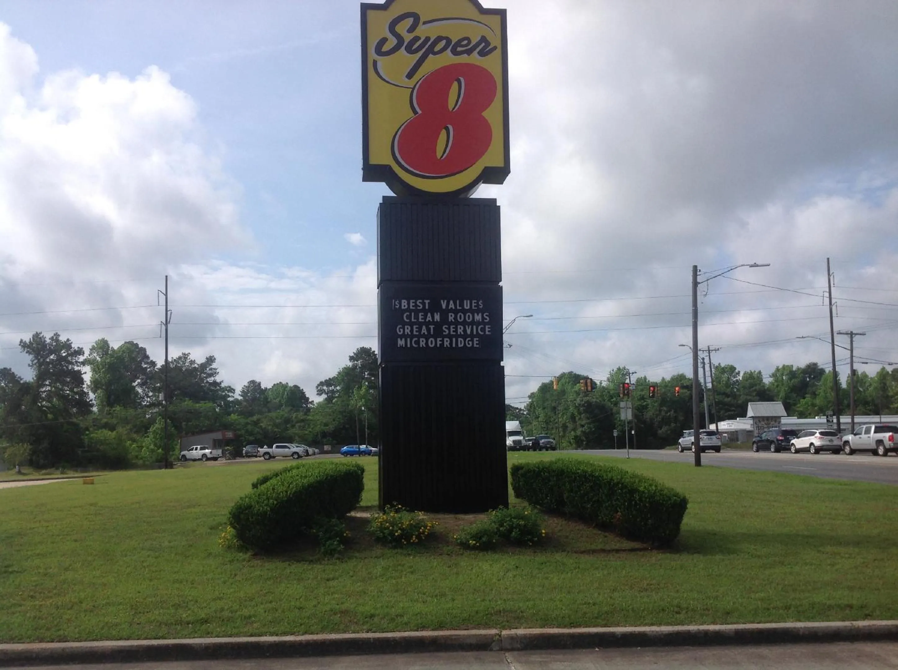 Property logo or sign in Super 8 by Wyndham Jasper TX