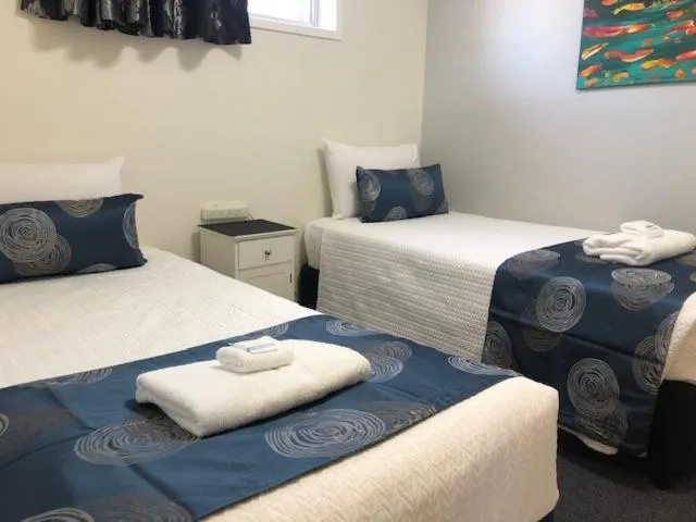 Bed in Charm City Motel