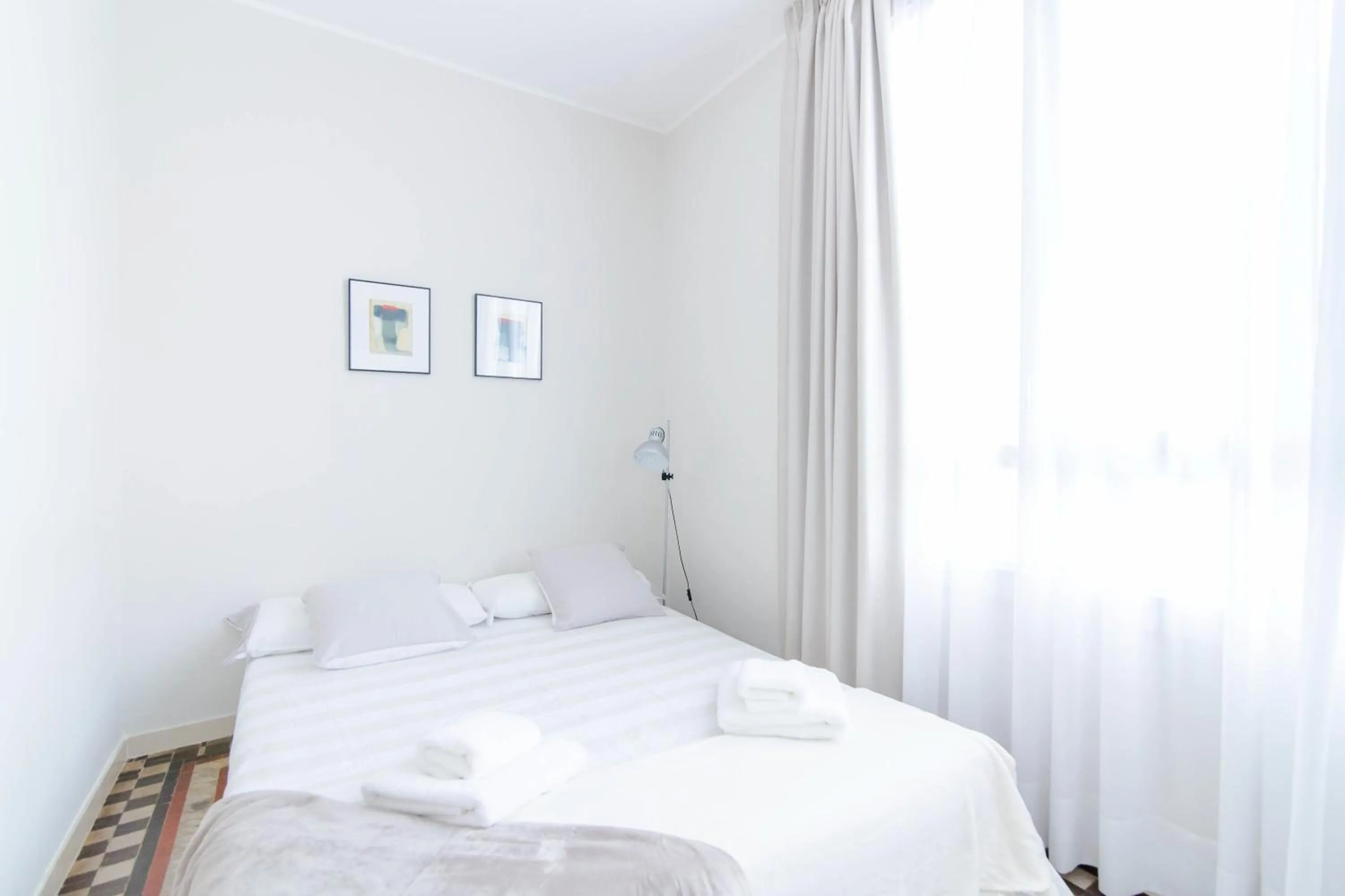 Bed in Pelayo Deluxe Apartments