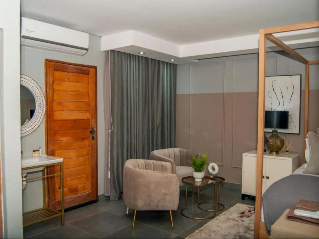 Seating area, Bed in The Lux Hotel and Resorts