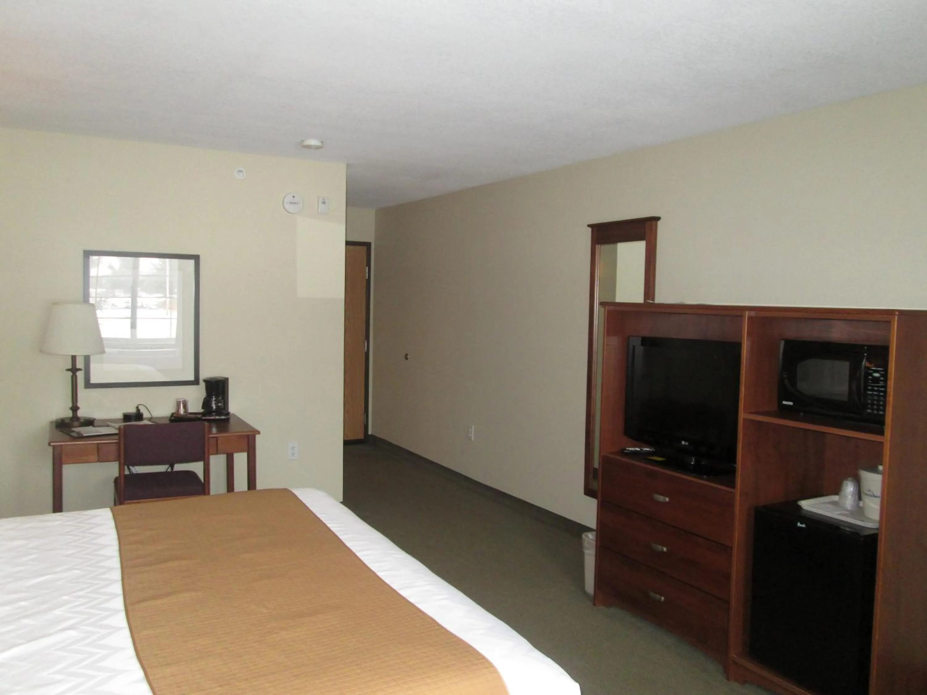 Bed in AmericInn by Wyndham Charlevoix