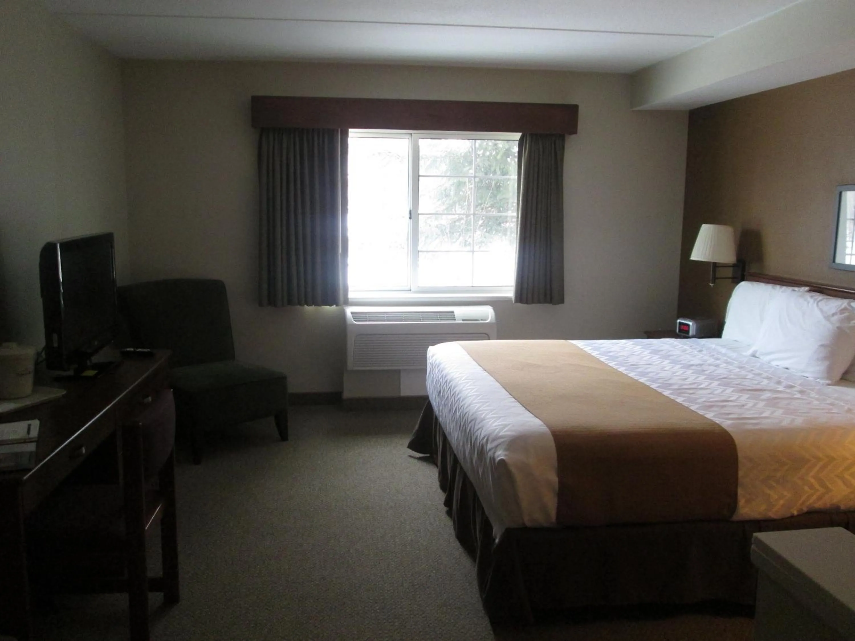 Bed in AmericInn by Wyndham Charlevoix