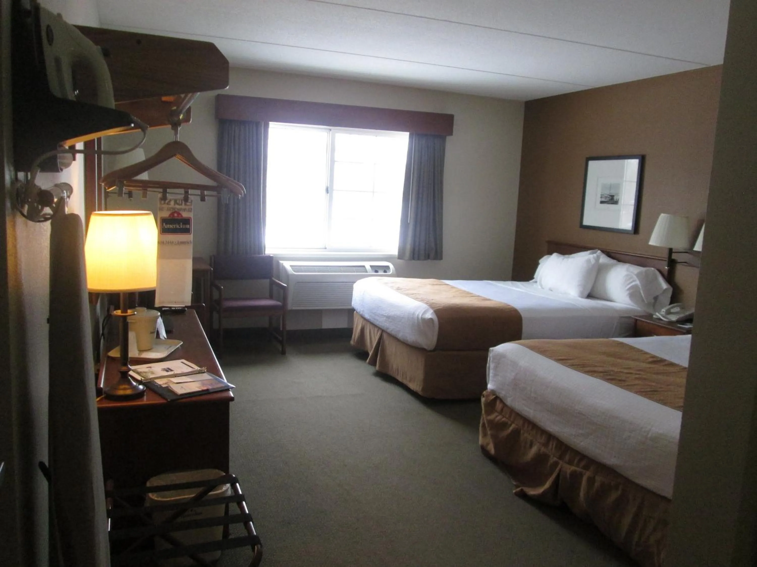 Bed in AmericInn by Wyndham Charlevoix