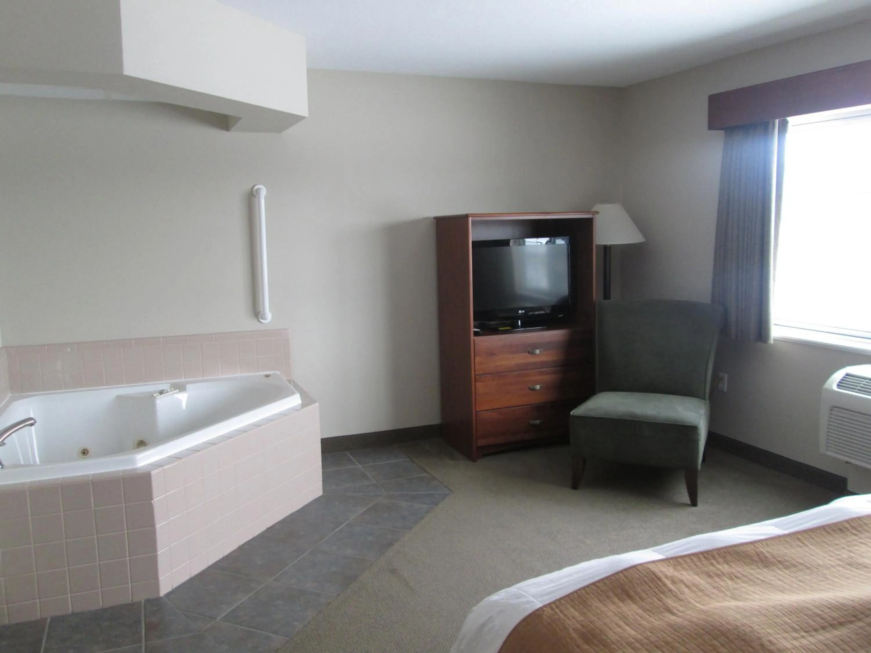 Bed in AmericInn by Wyndham Charlevoix