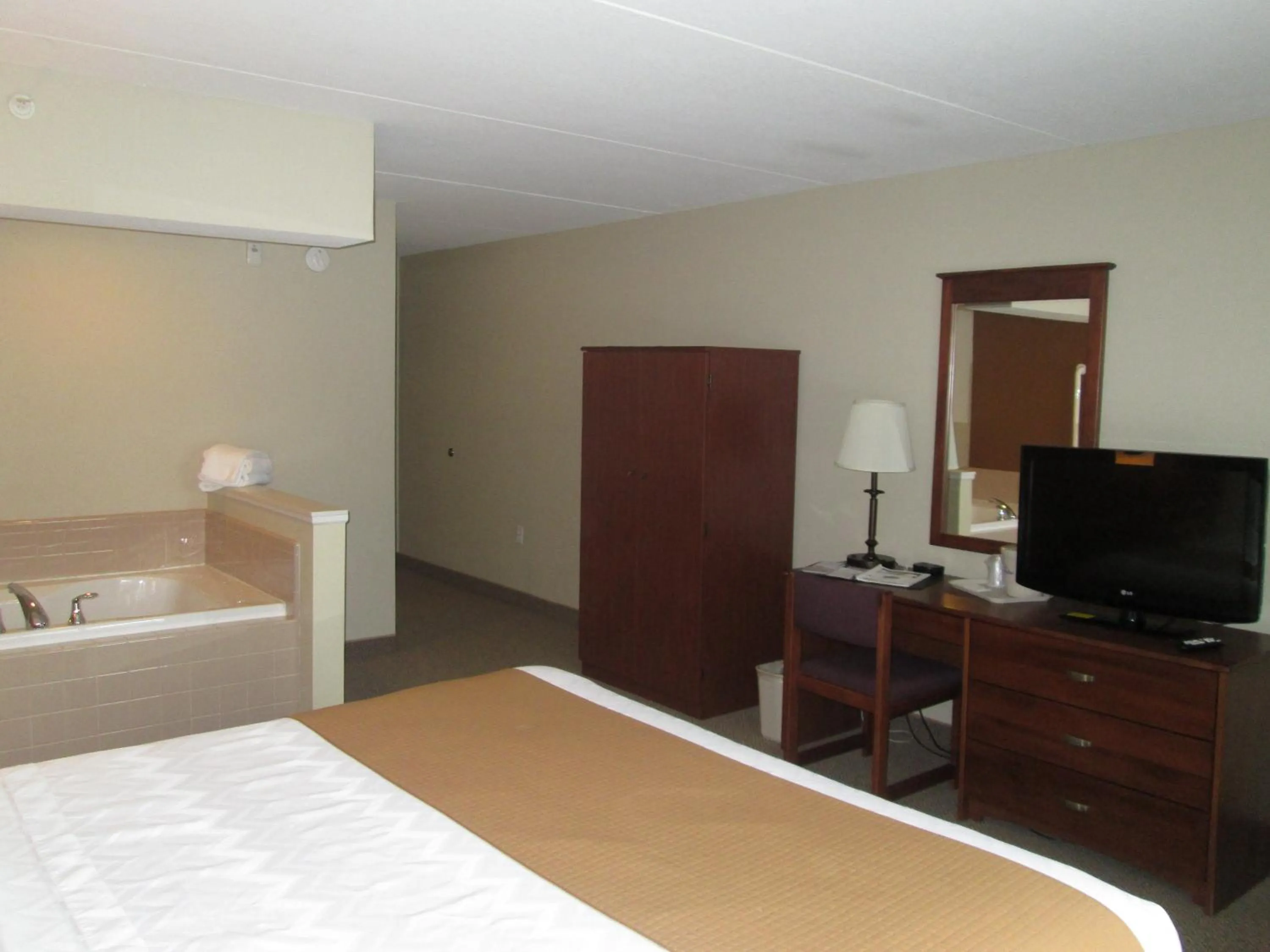 Bed in AmericInn by Wyndham Charlevoix