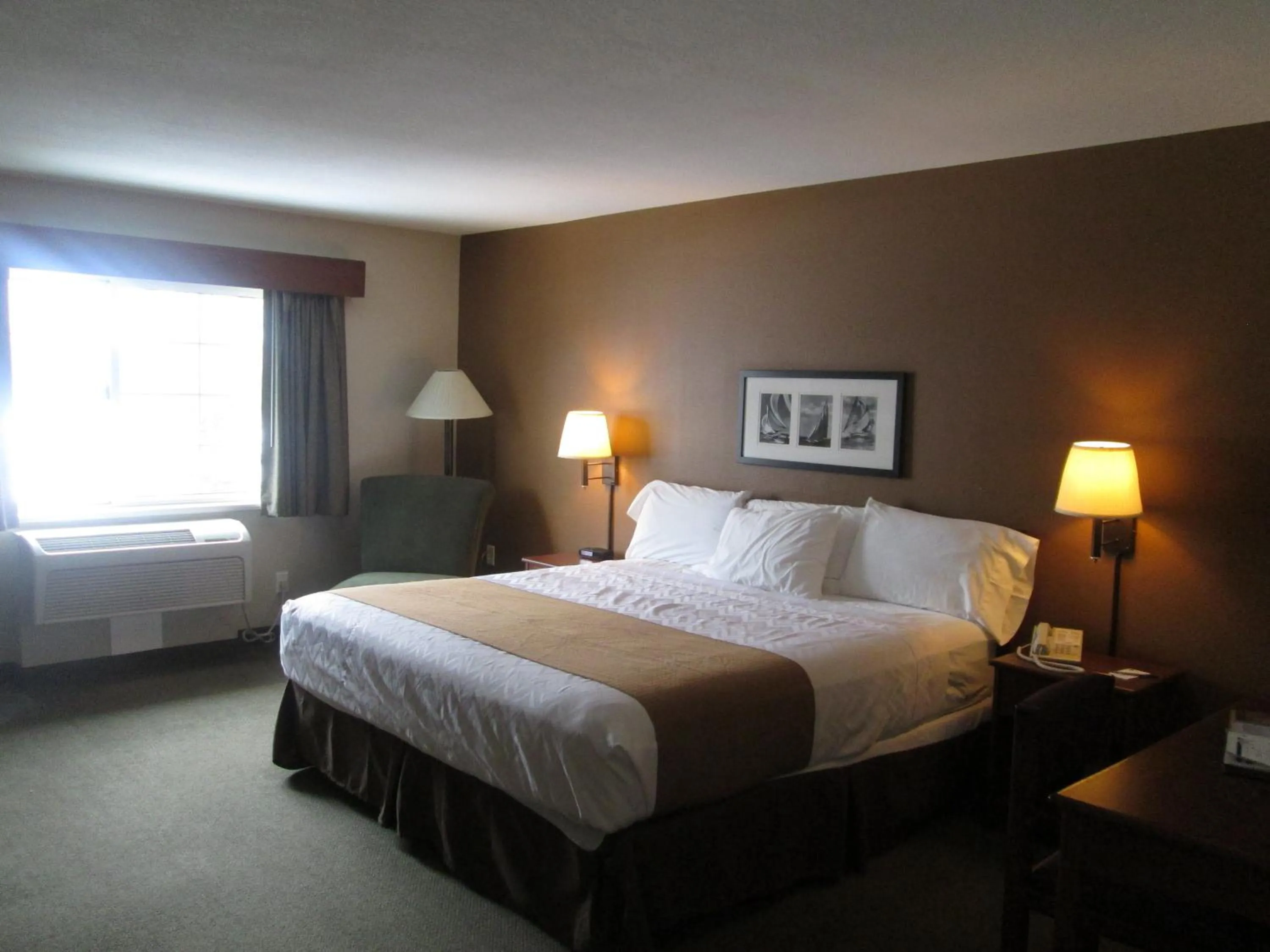 Bed in AmericInn by Wyndham Charlevoix
