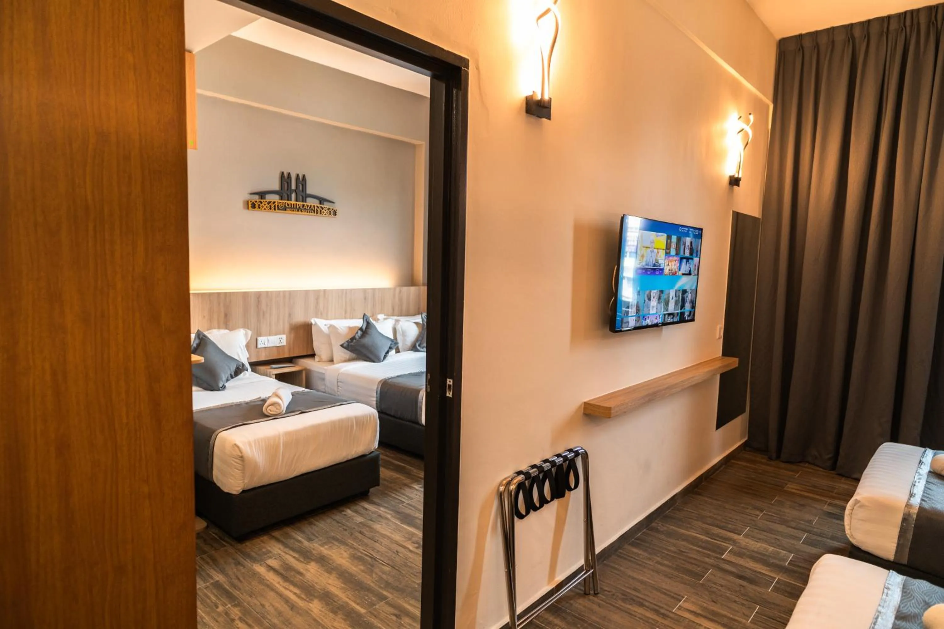 Bed in DJ Citi Plaza Hotel & Suites