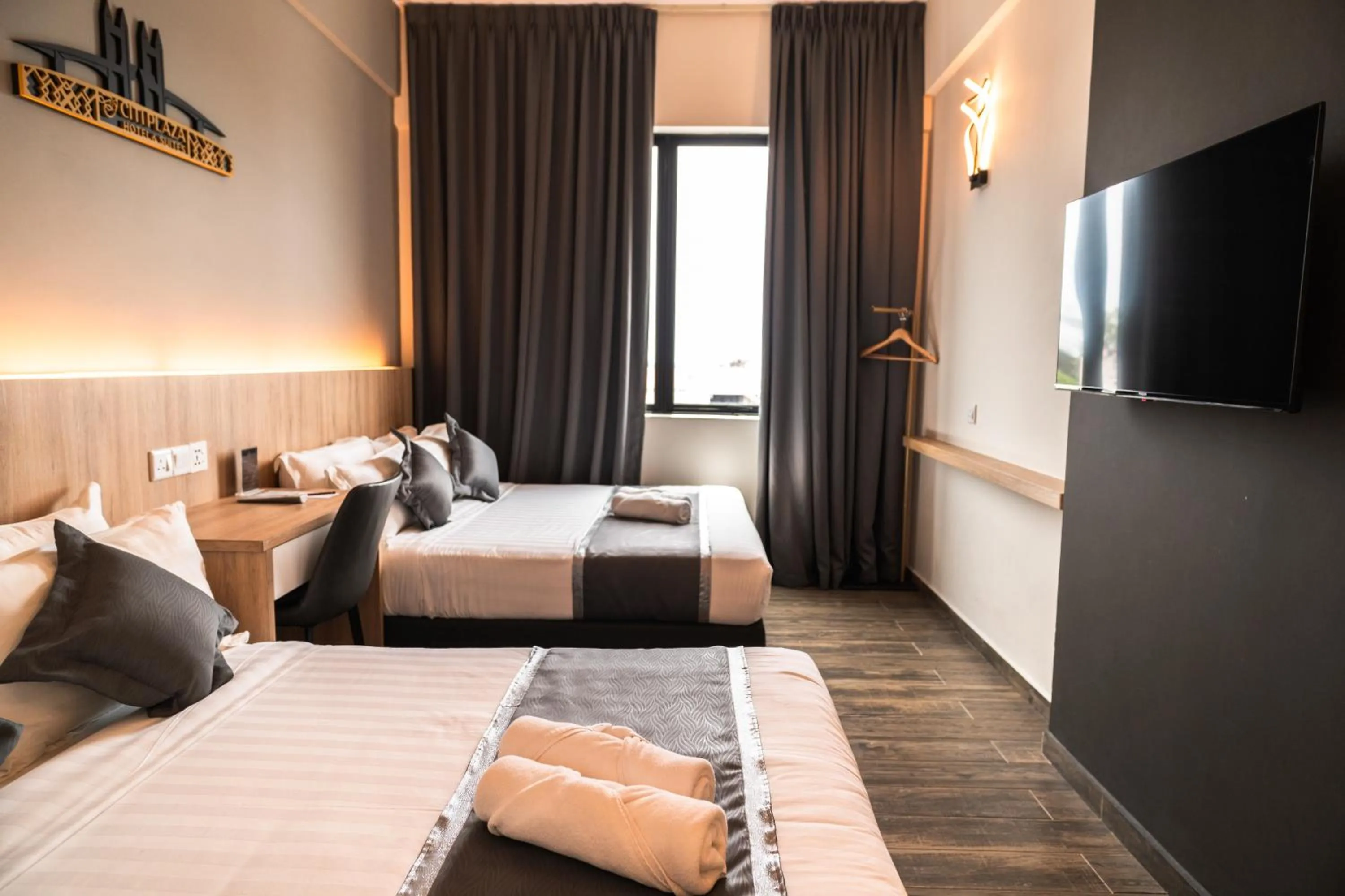 Bed in DJ Citi Plaza Hotel & Suites