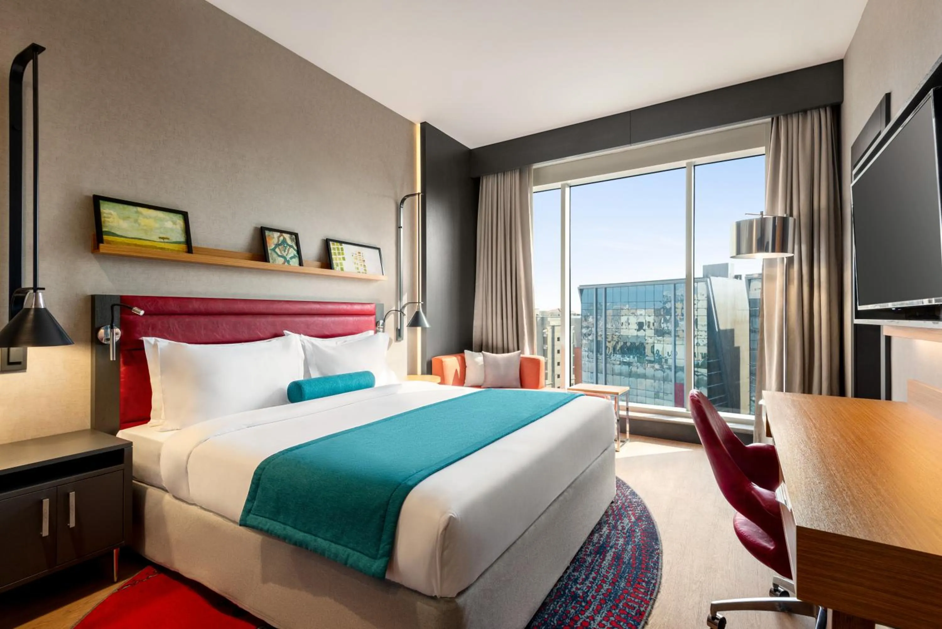 Communal lounge/ TV room, Bed in Ramada Encore Al Khobar Corniche