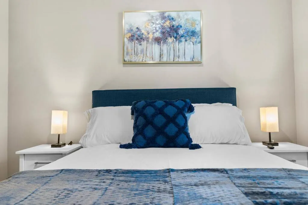 Bed in Luxury Living: 1BR Condo w/ Resort-Style Amenities