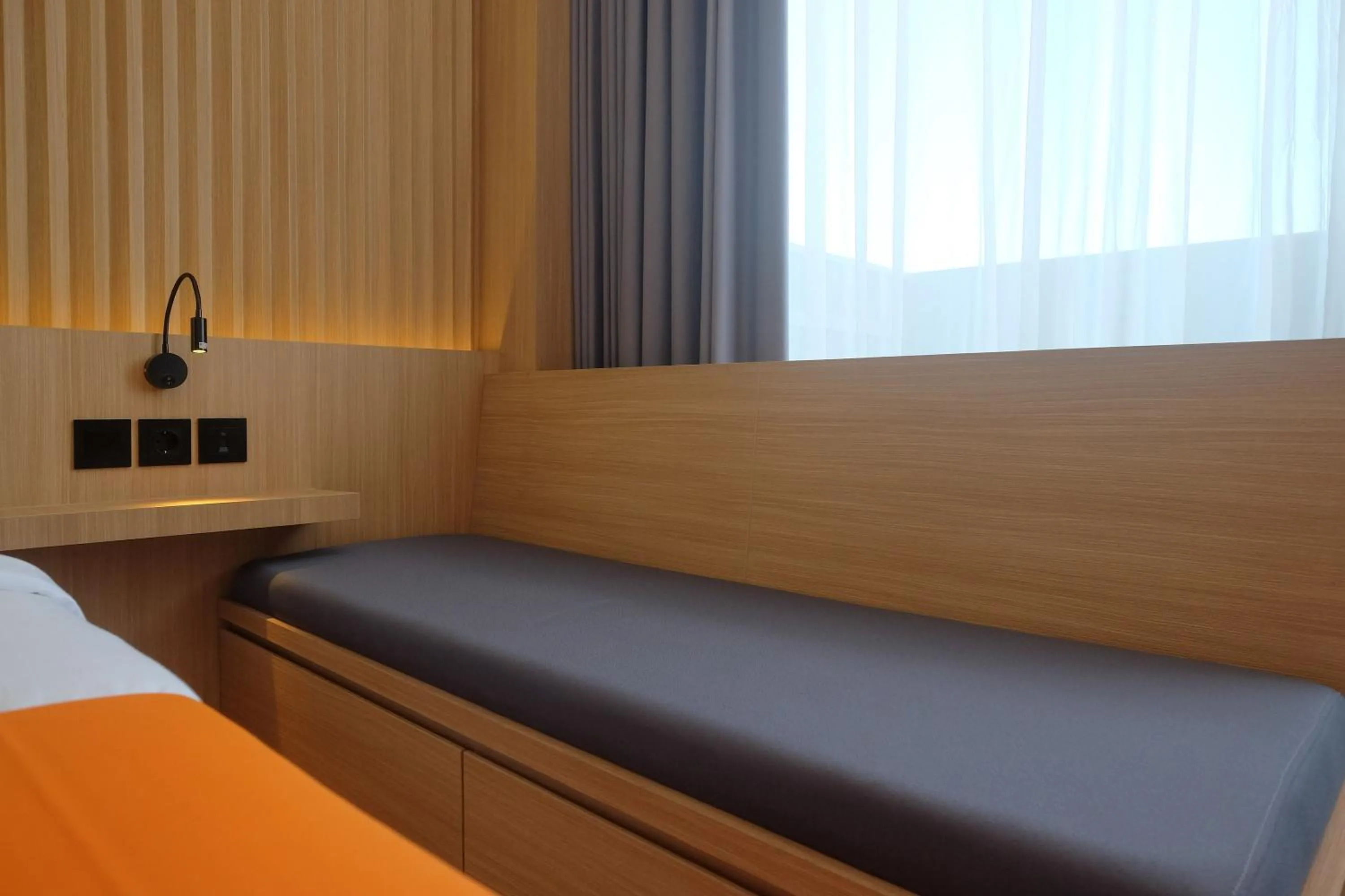 Bed in Sans Hotel RG Living Jogja by RedDoorz