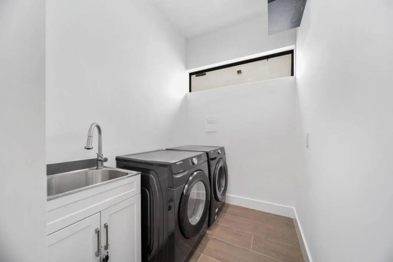 washing machine in The Elements Home with 2 Pools