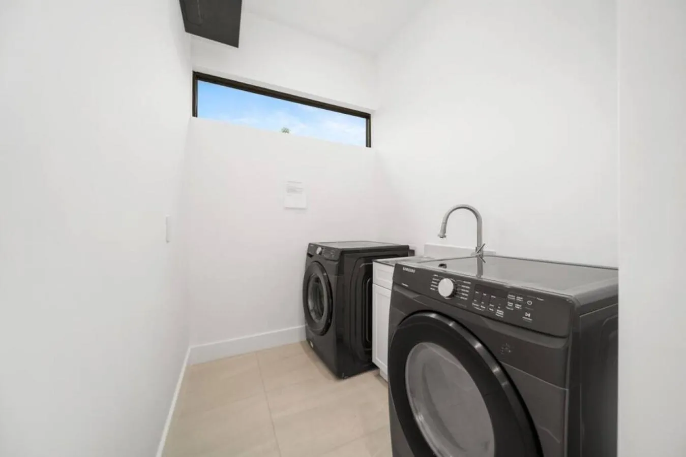 washing machine in The Elements Home with 2 Pools