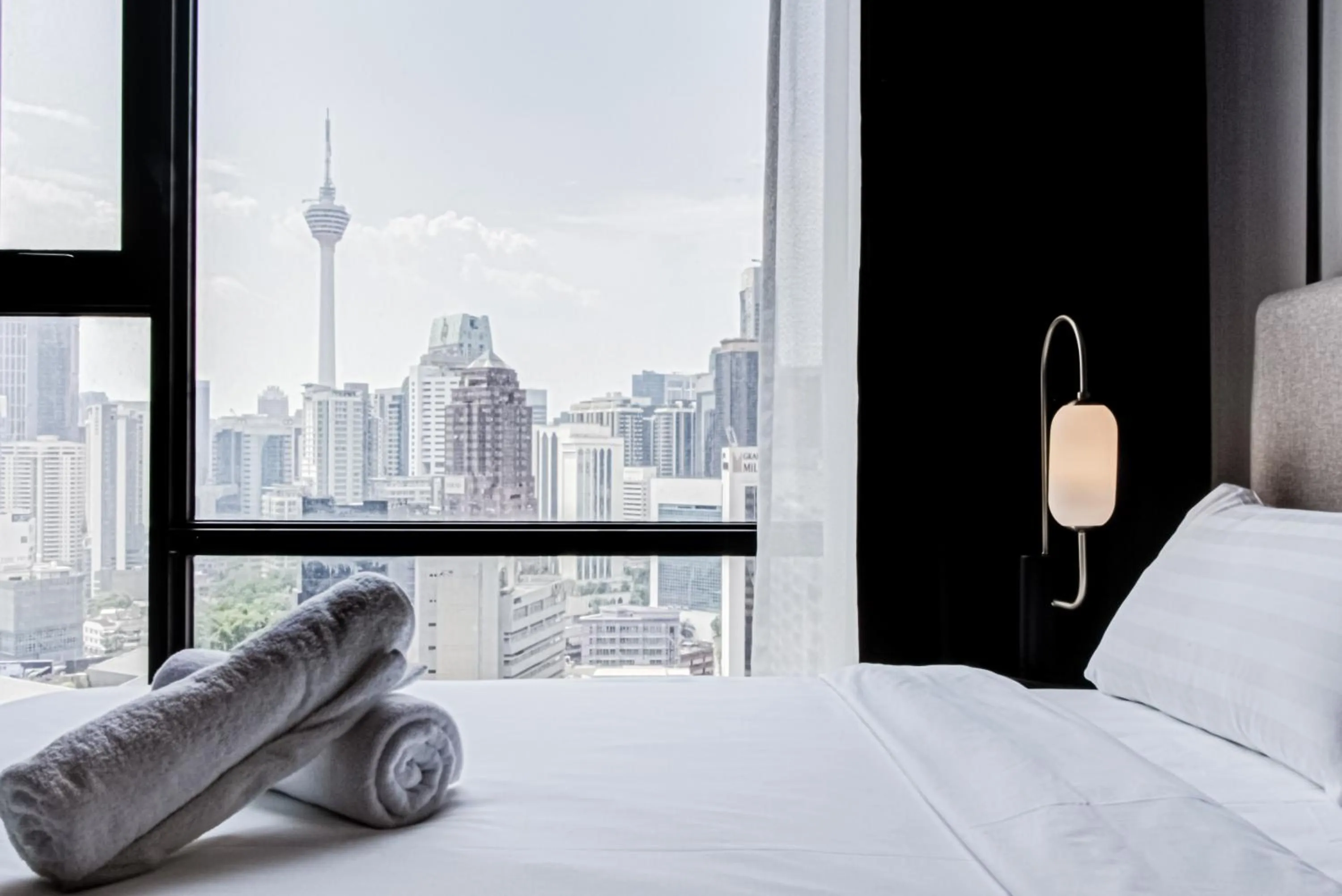 Bed in Axon Residence at Pavilion KLCC KL Tower view by KIMIRO