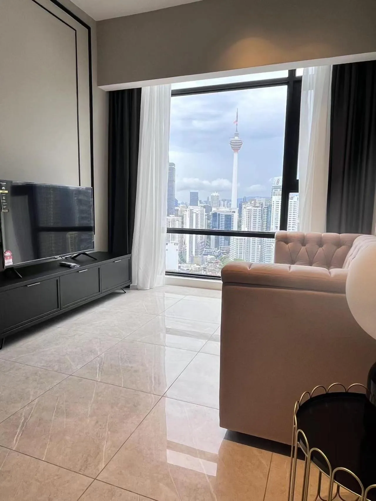 Living room in Axon Residence at Pavilion KLCC KL Tower view by KIMIRO