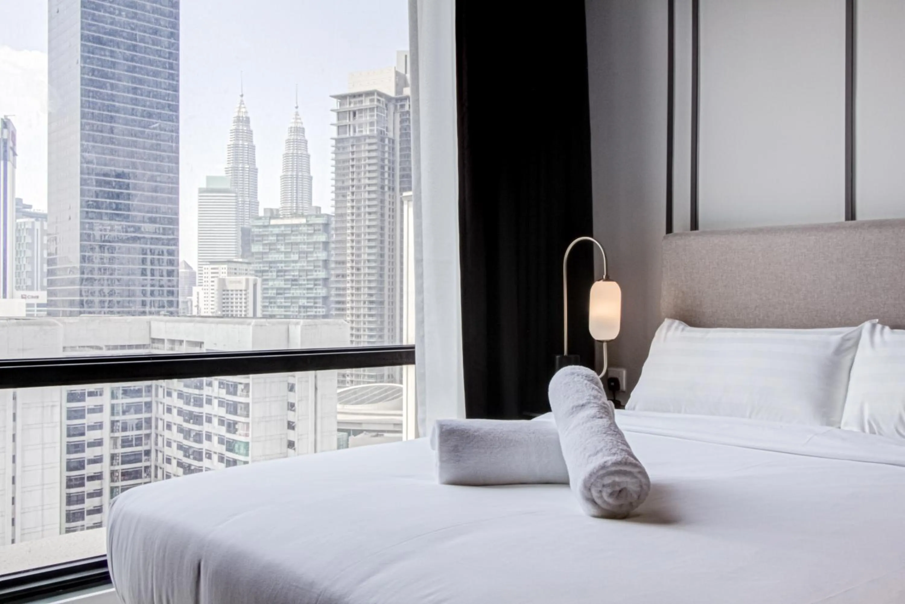 Bed in Axon Residence at Pavilion KLCC KL Tower view by KIMIRO