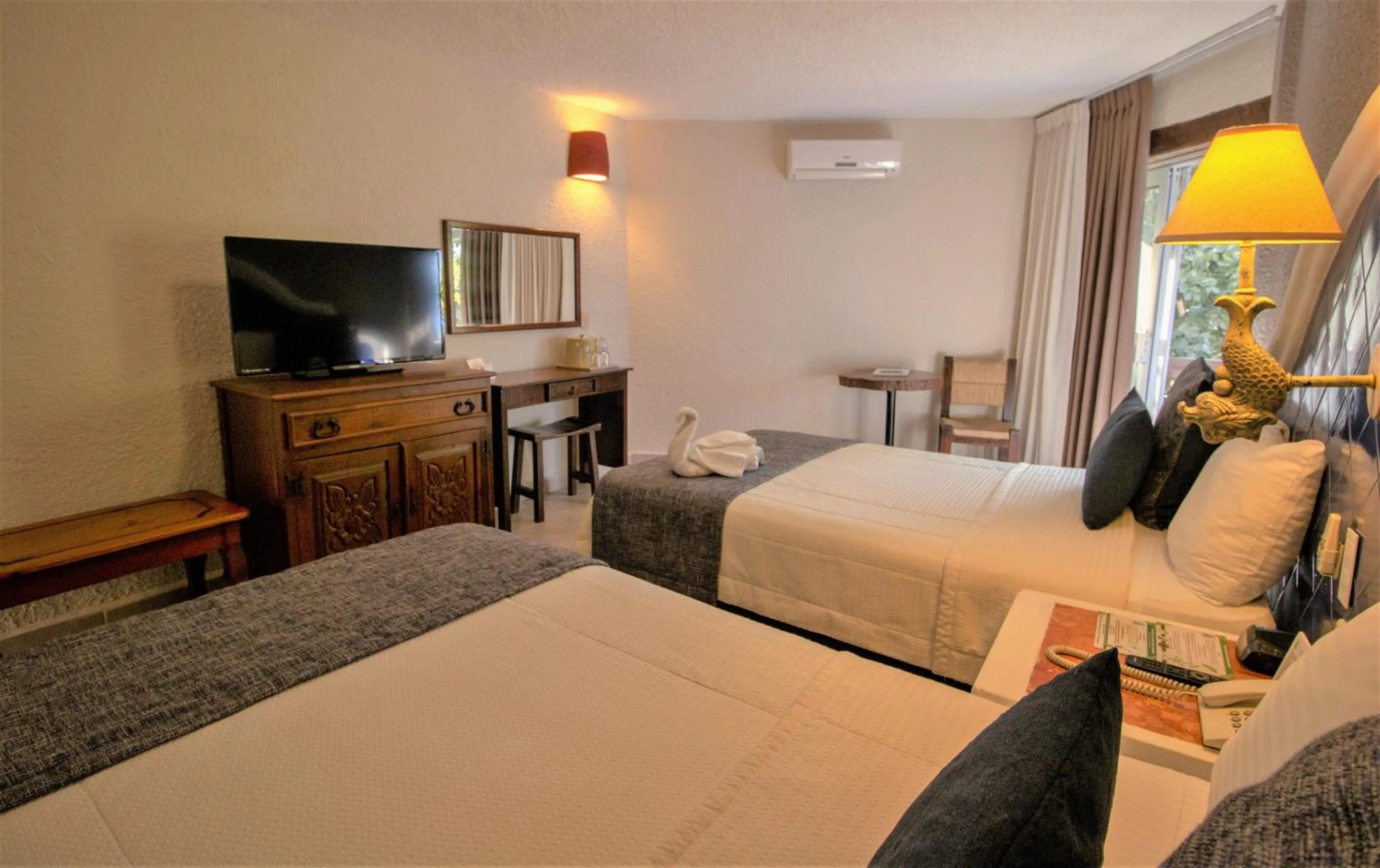 Bed in Casa del Mar Cozumel Hotel & Dive Resort with free access to an exclusive beach club