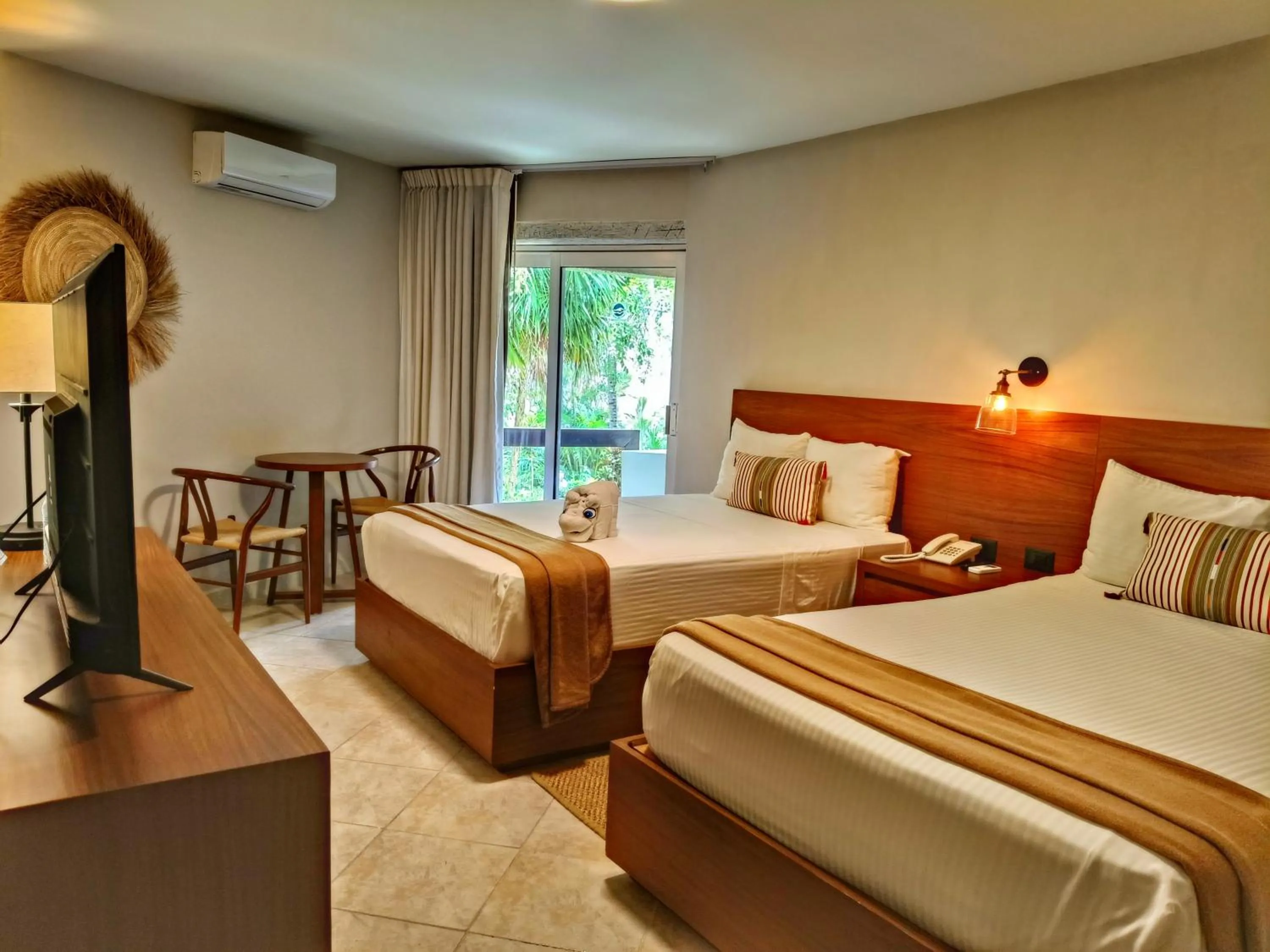 Bed in Casa del Mar Cozumel Hotel & Dive Resort with free access to an exclusive beach club