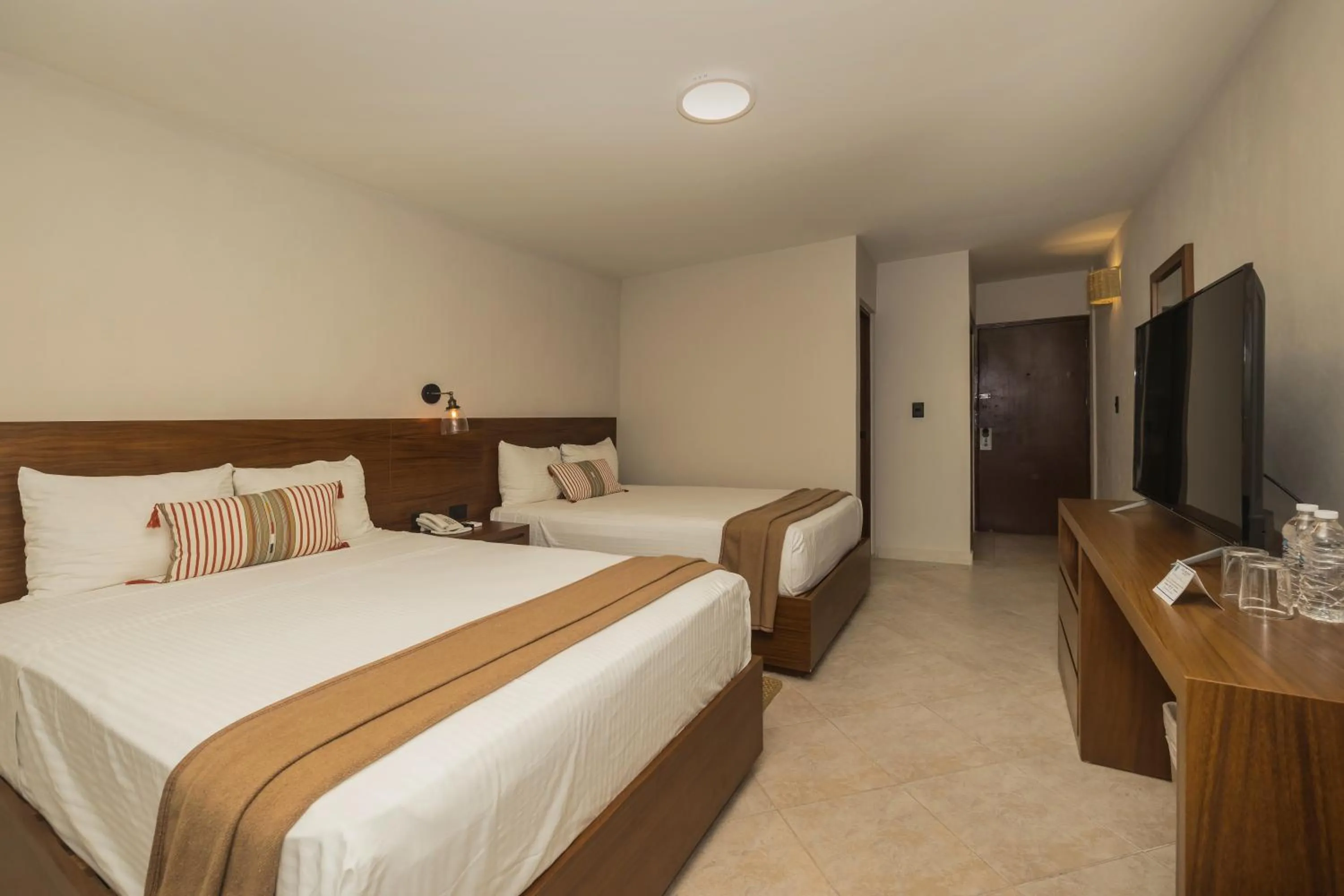 Bed in Casa del Mar Cozumel Hotel & Dive Resort with free access to an exclusive beach club