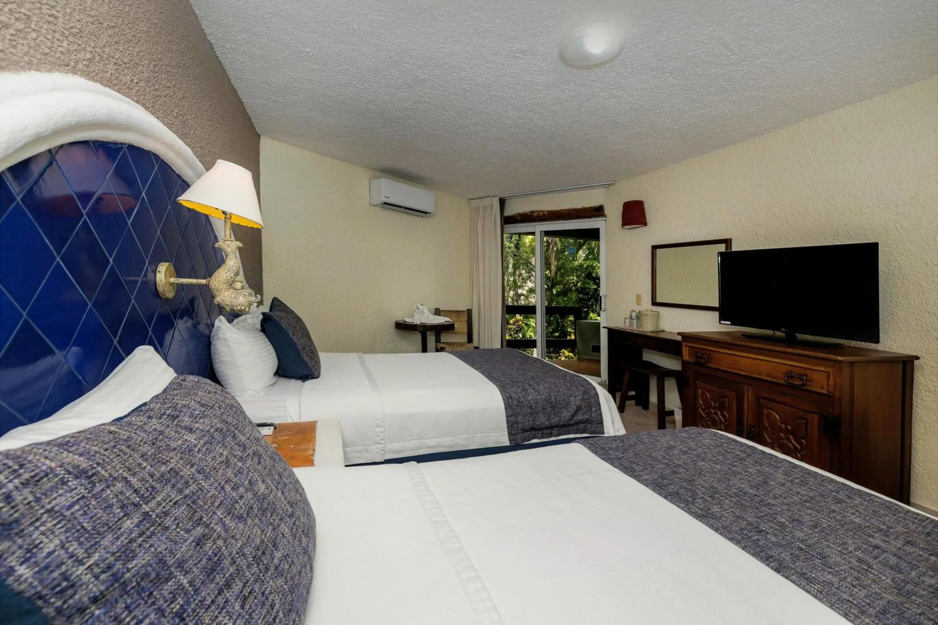 Bed in Casa del Mar Cozumel Hotel & Dive Resort with free access to an exclusive beach club