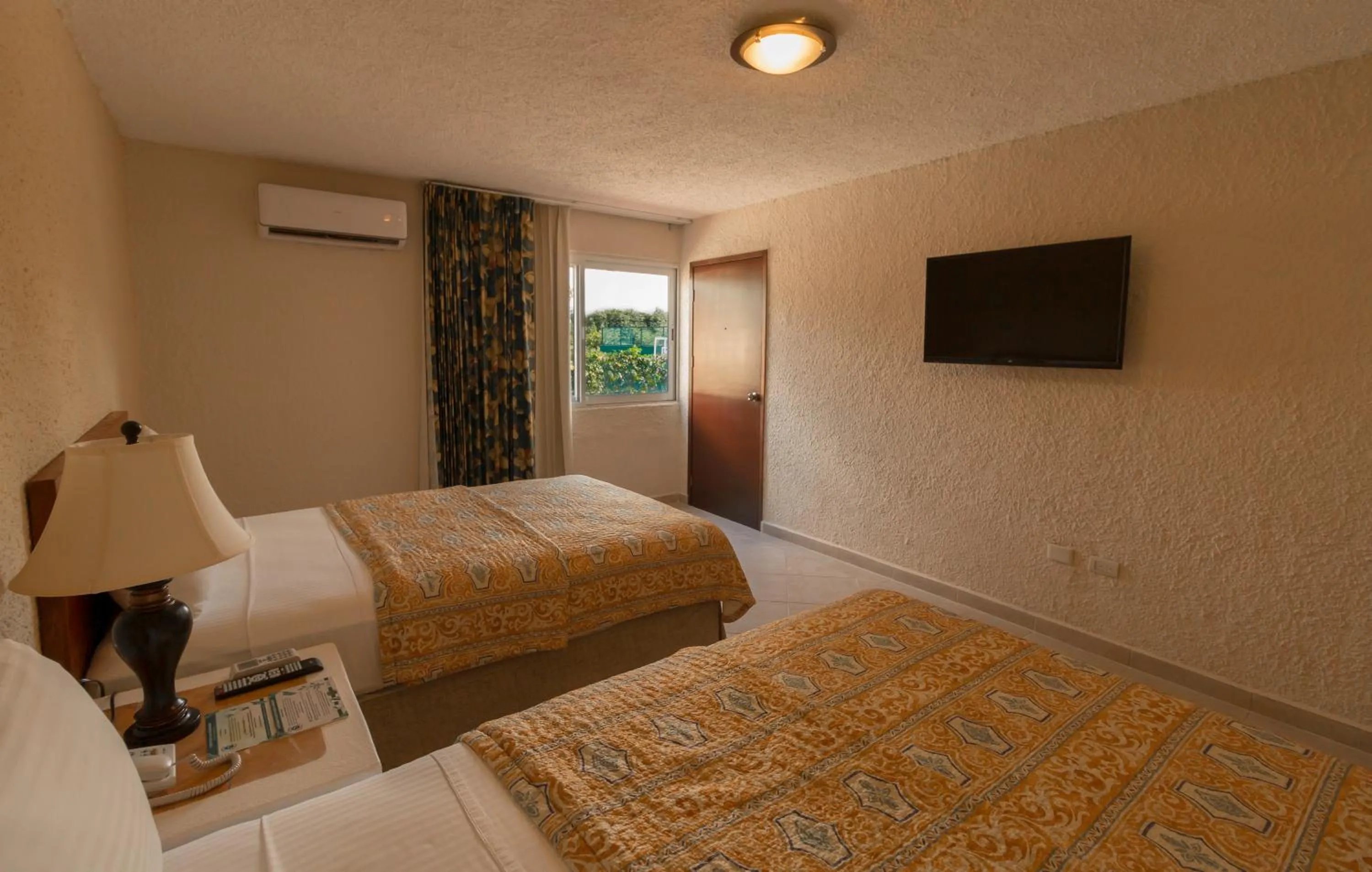 Bed in Casa del Mar Cozumel Hotel & Dive Resort with free access to an exclusive beach club