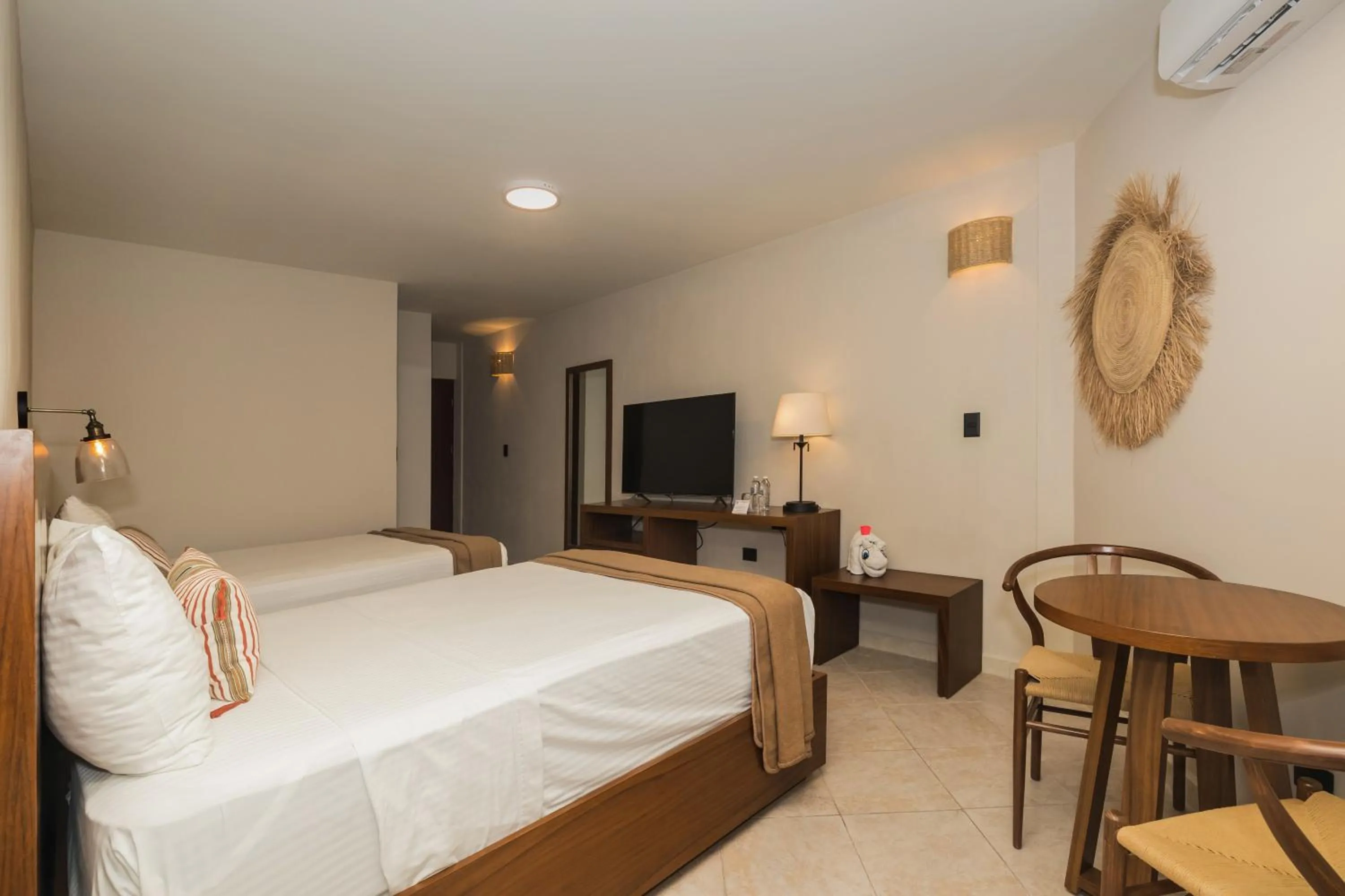 Bed in Casa del Mar Cozumel Hotel & Dive Resort with free access to an exclusive beach club