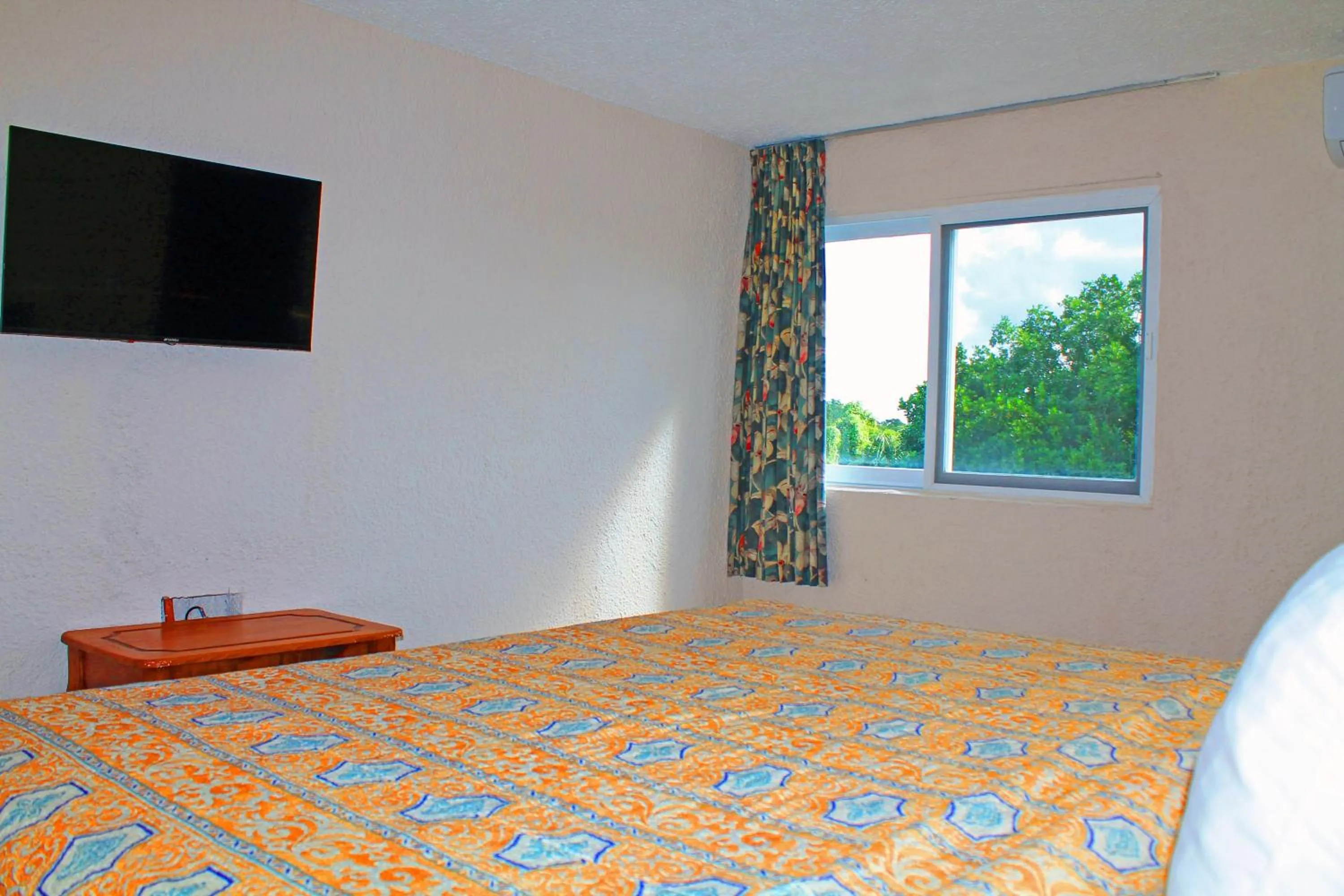 Bed in Casa del Mar Cozumel Hotel & Dive Resort with free access to an exclusive beach club