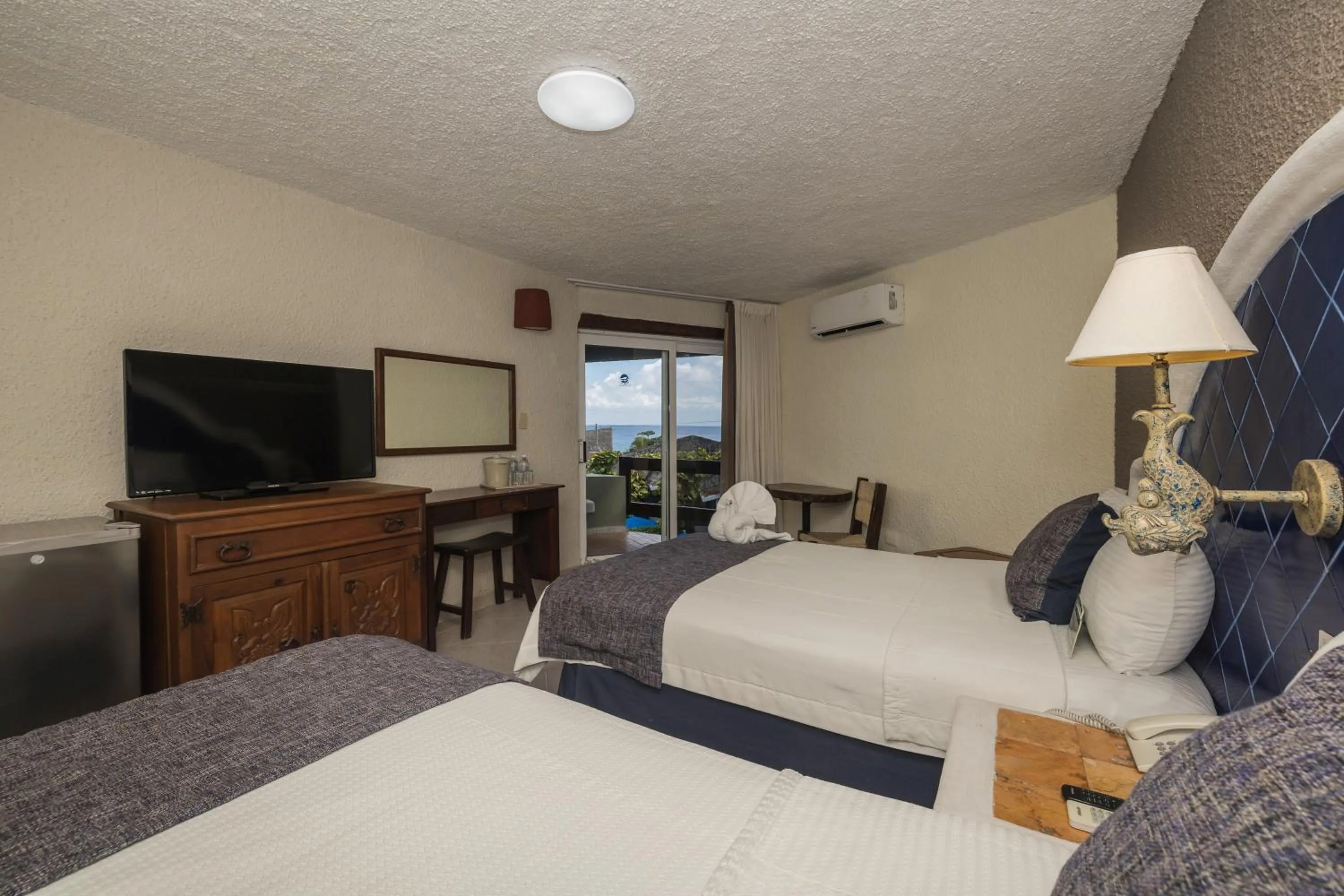 Bedroom, Bed in Casa del Mar Cozumel Hotel & Dive Resort with free access to an exclusive beach club