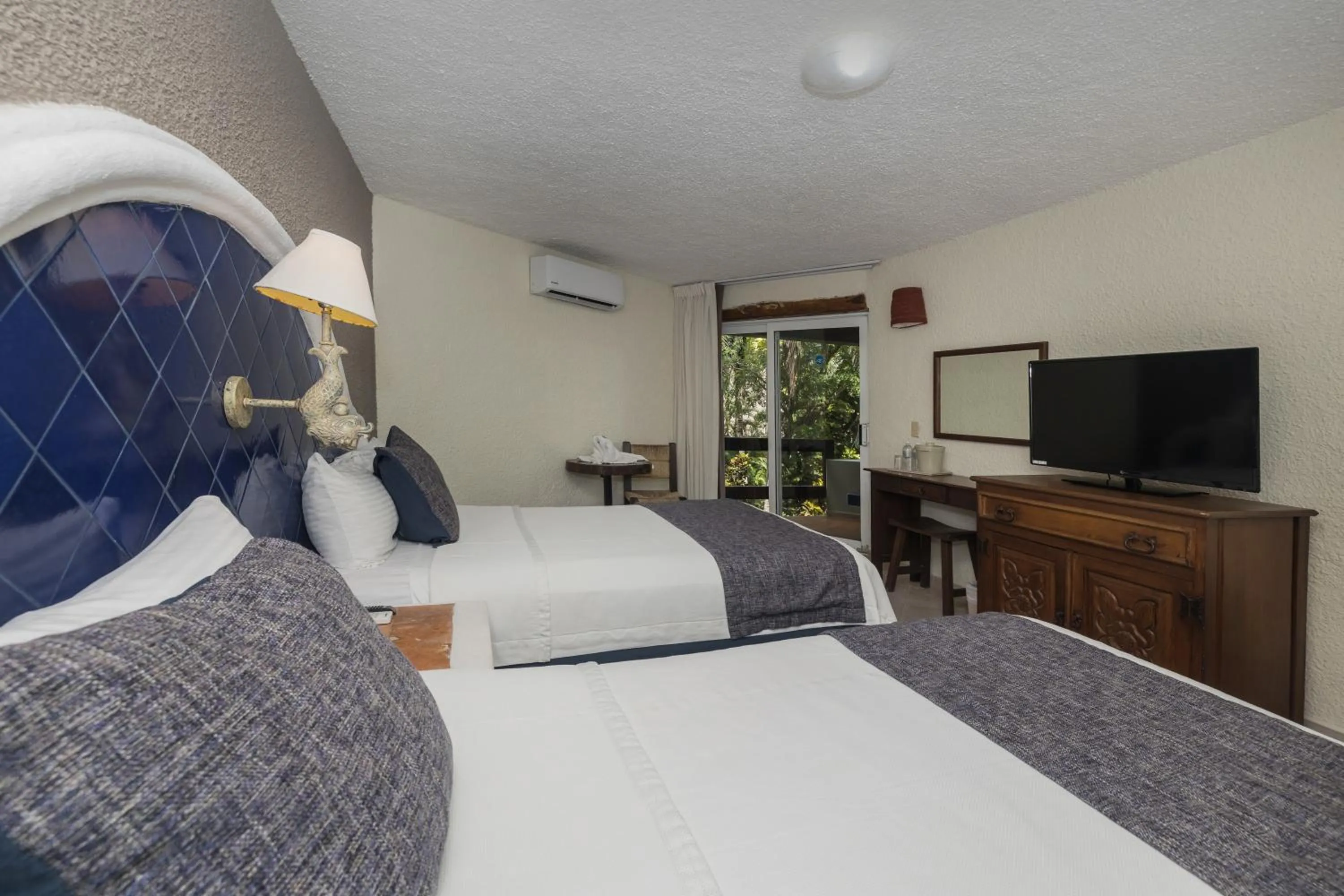 Bed in Casa del Mar Cozumel Hotel & Dive Resort with free access to an exclusive beach club
