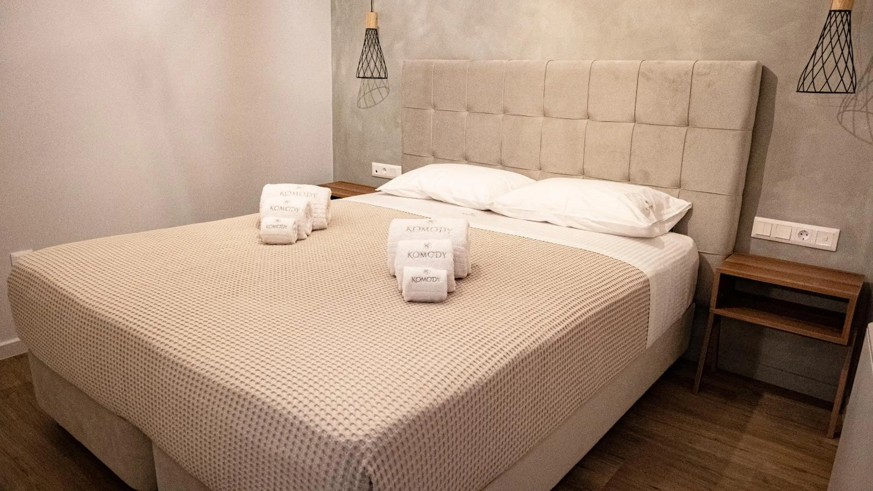 Bed in Komody Apartments