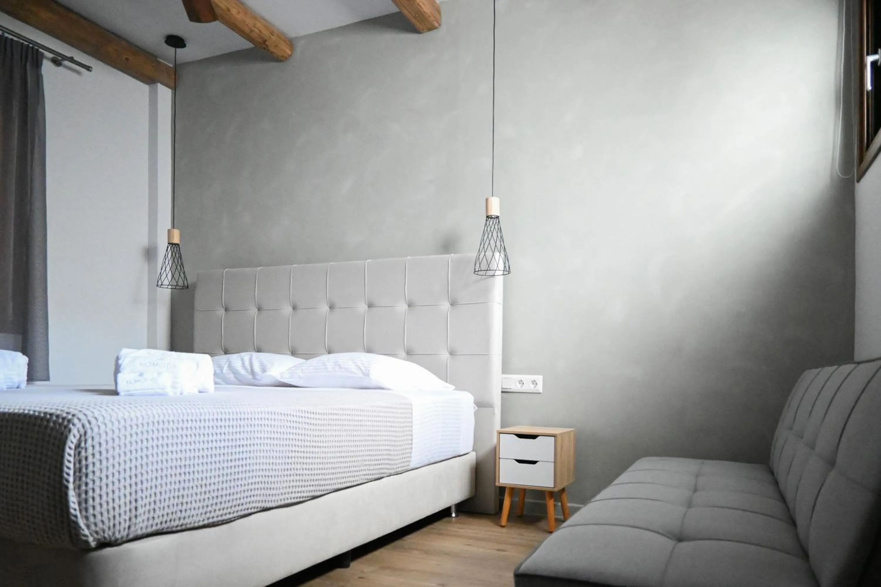 Bed in Komody Apartments