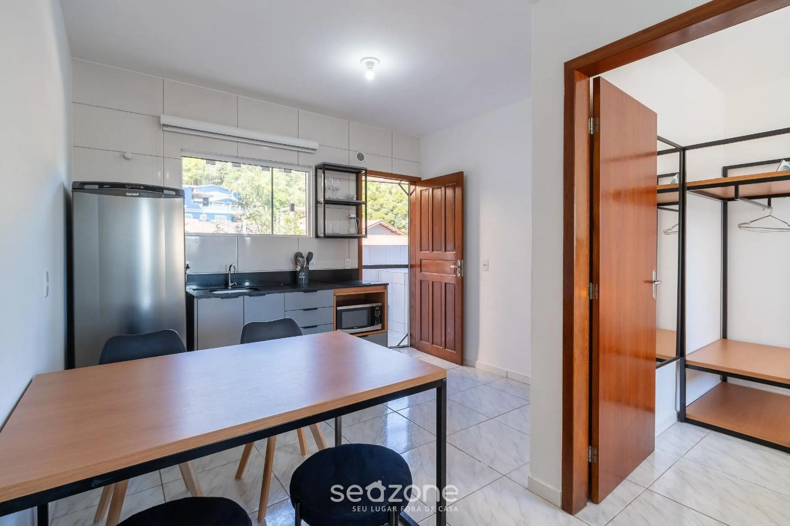 Kitchen or kitchenette in Apartamentos em Jurerê - JMA