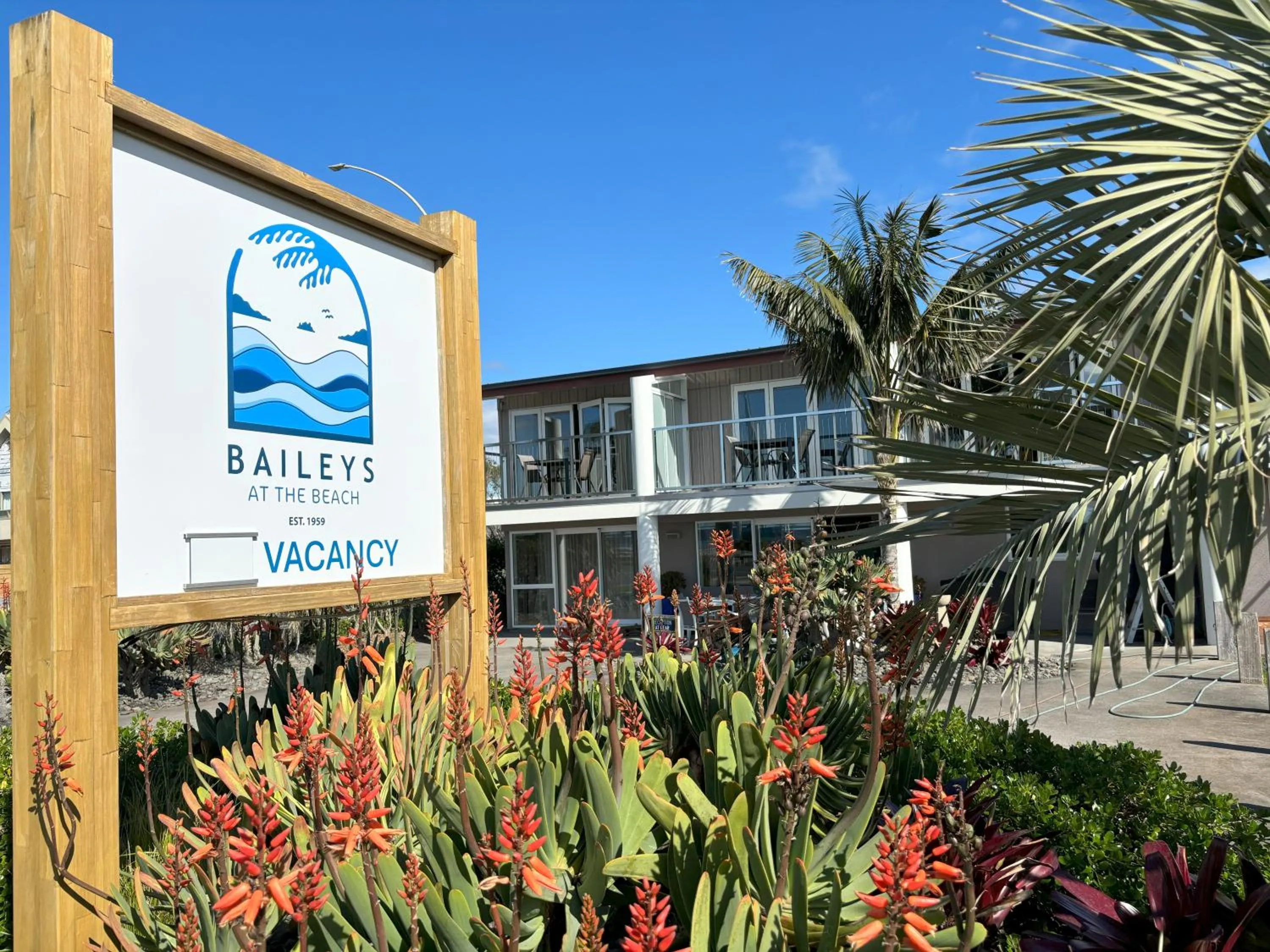 Property logo or sign in Baileys At The Beach