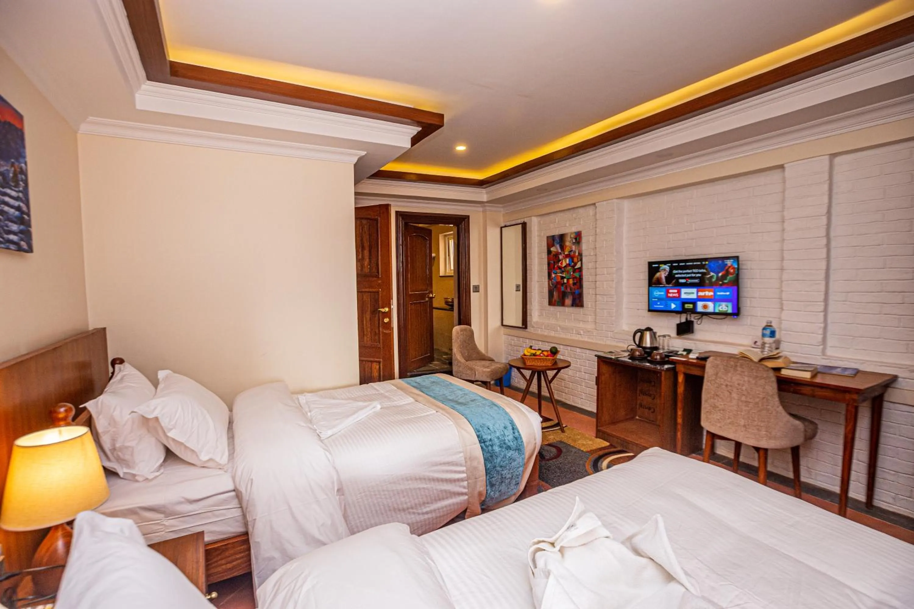 Communal lounge/ TV room, Bed in Darbar Heritage Inn