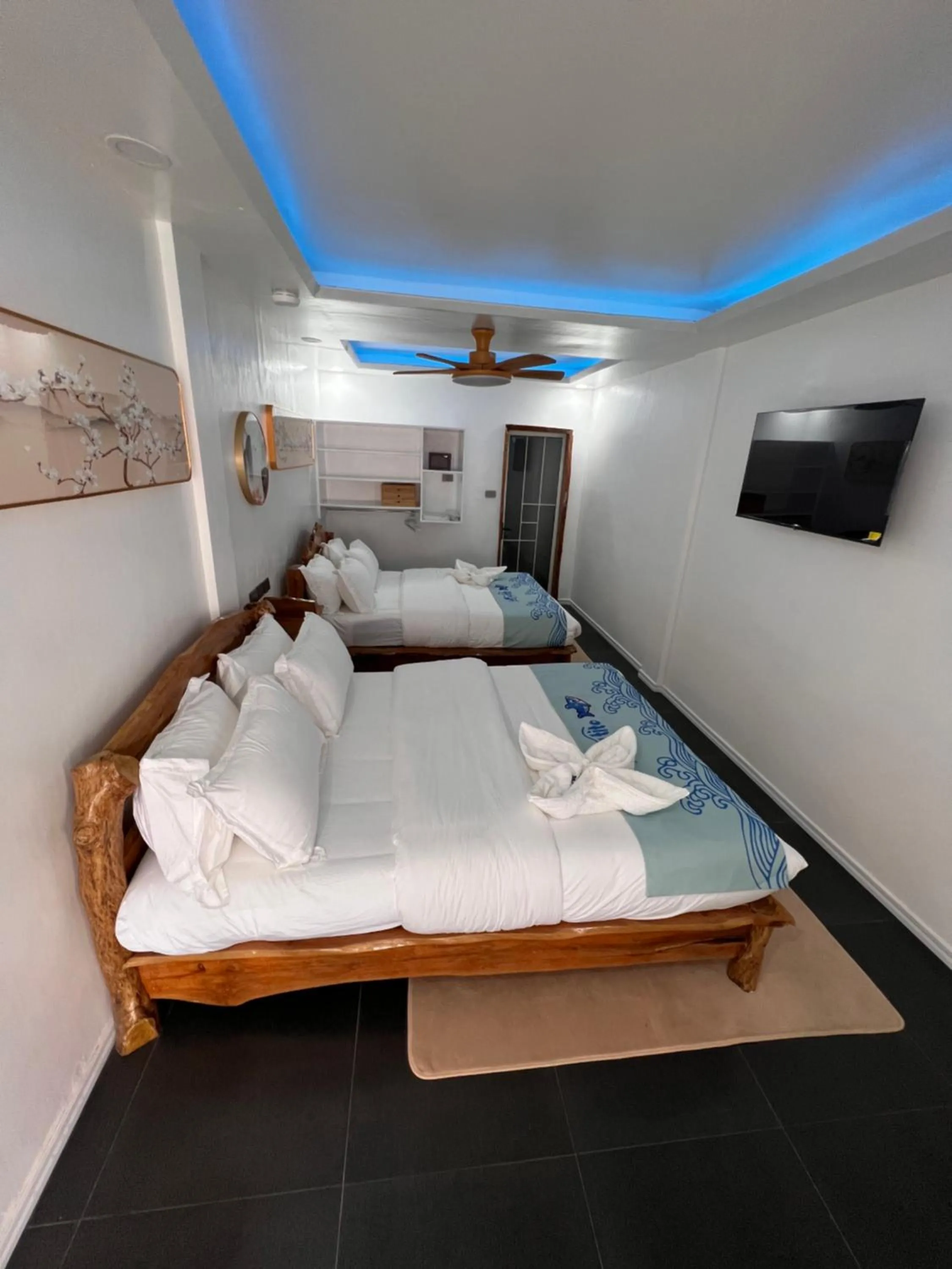 Bed in Lucky Tito PG Dive Resort