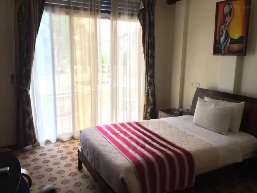 Bed in Hotel Karisimbi