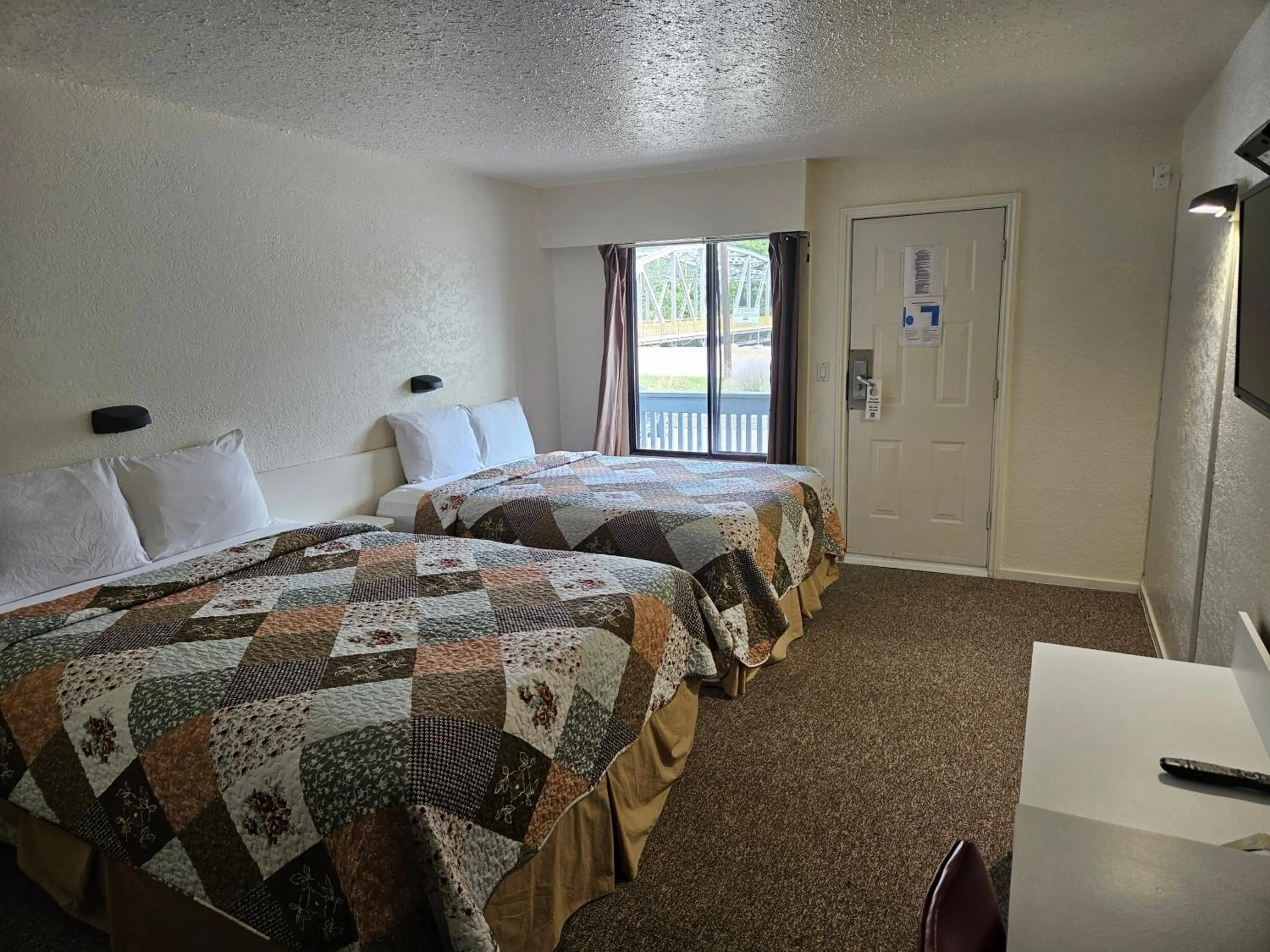 Bed in Granby River Inn & Suites