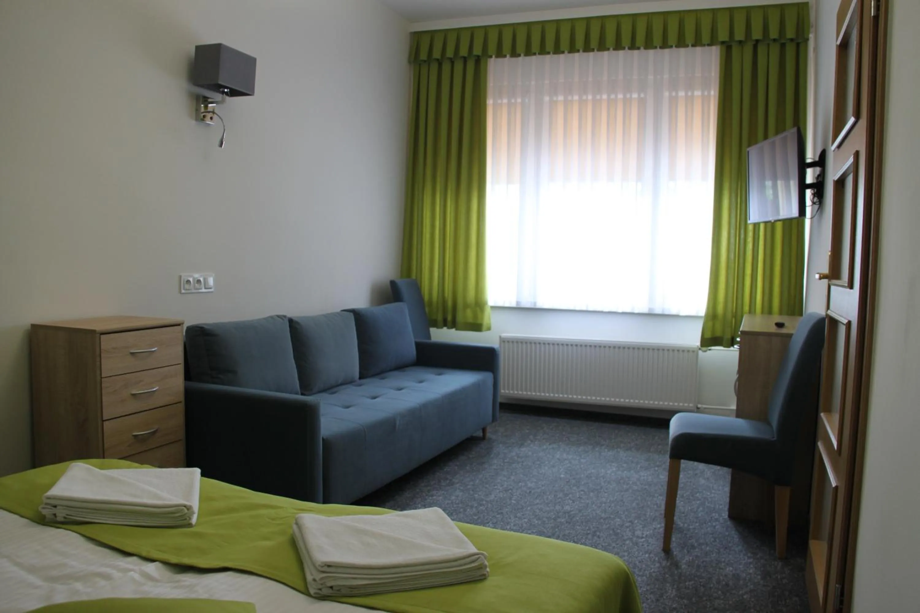 Seating area, Bed in Hotel Zielony & OW Borowik & Pensjonat Manhattan - Centrum Rekreacji i Wypoczynku GASTROTUR