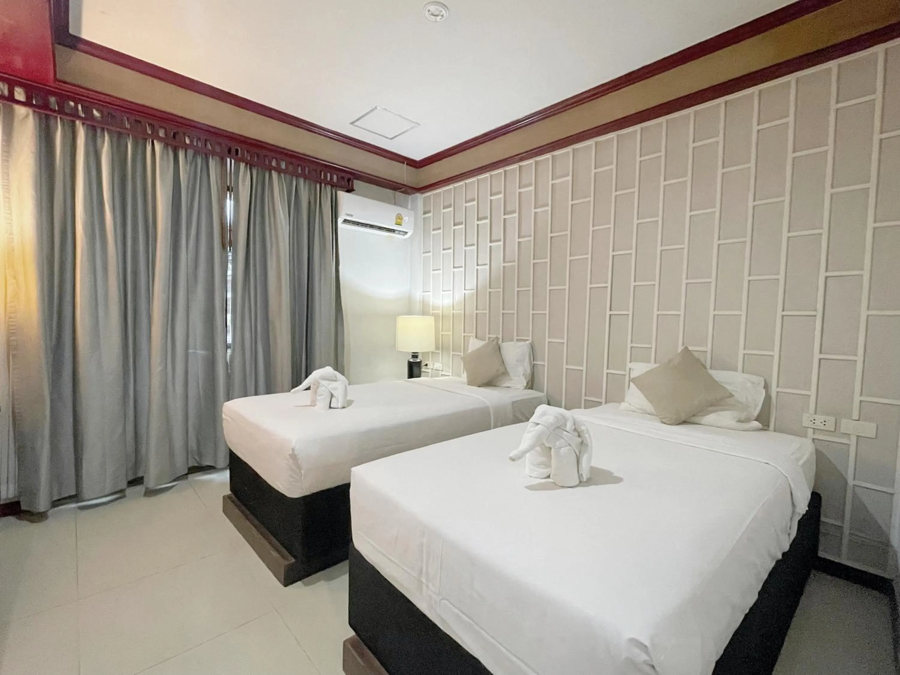 Bed in THE TOP PATONG RESORT.