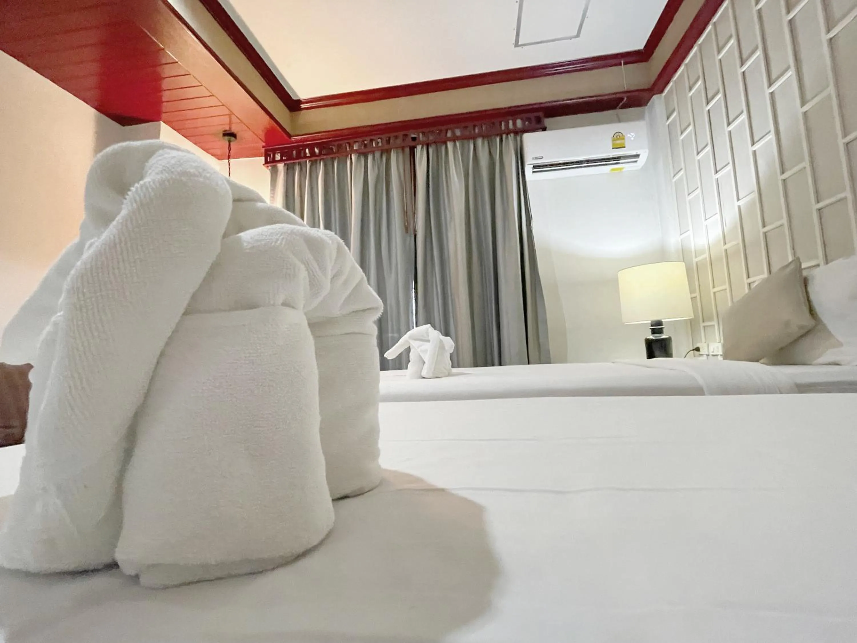 Bed in THE TOP PATONG RESORT.