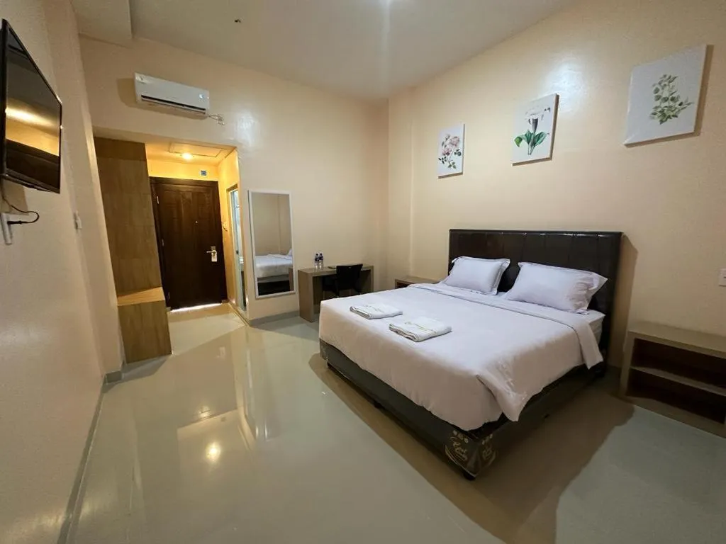 Bed in GRAND PANDAN HOTEL