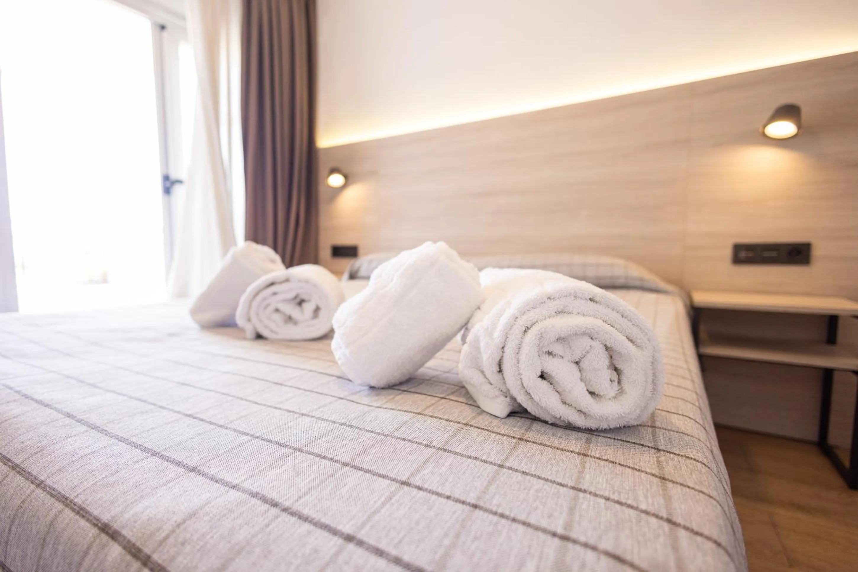 towels, Bed in Apartamentos Odysea By Apartamentos Valentia