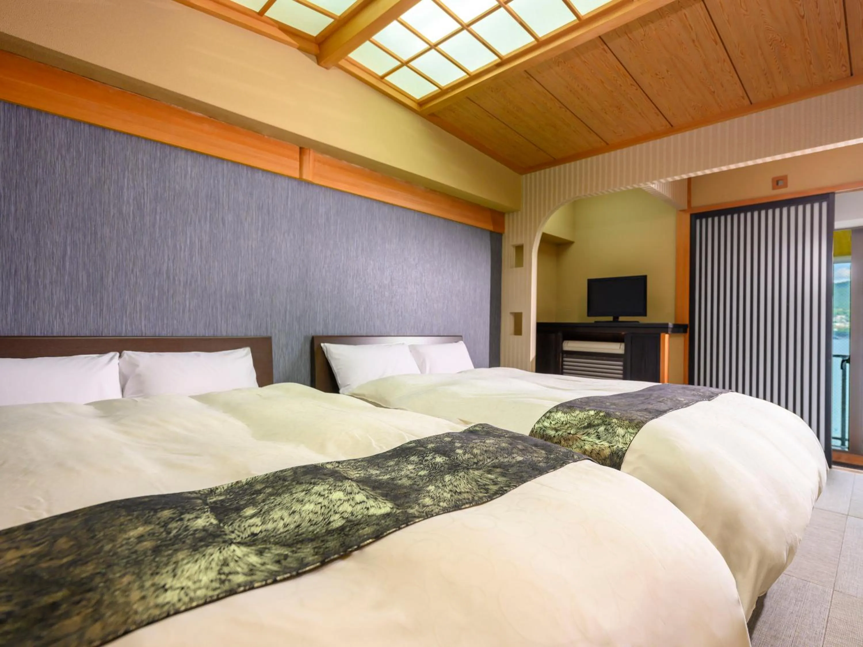 Bed in KAMENOI HOTEL Nachi Katsuura