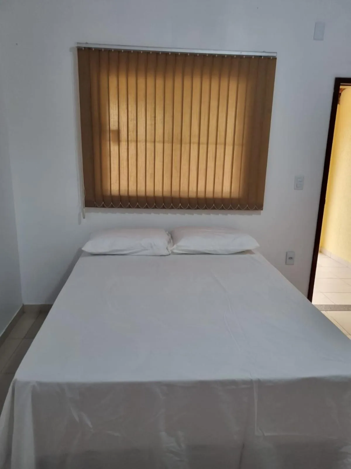 Bed in Pousada Talismã