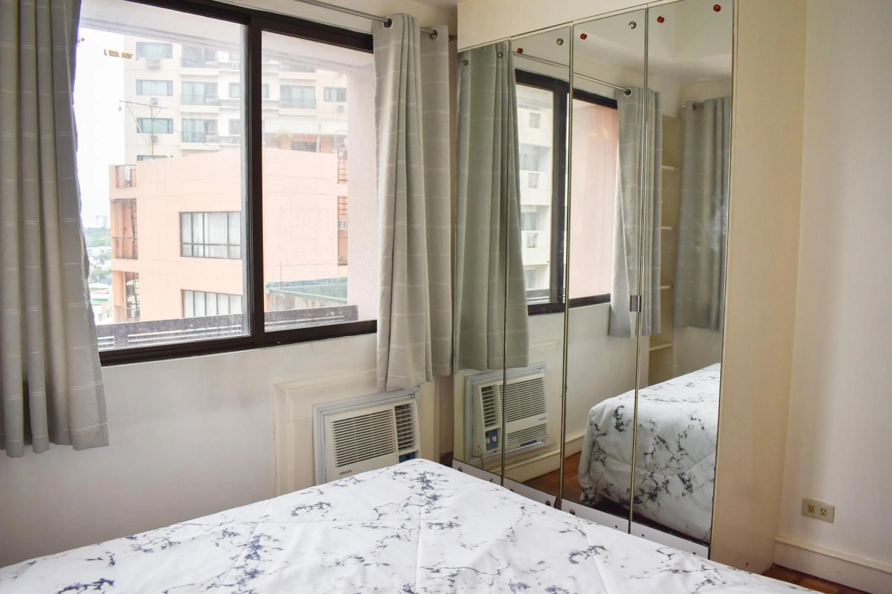 Bed in Sunette Tower Suites Makati