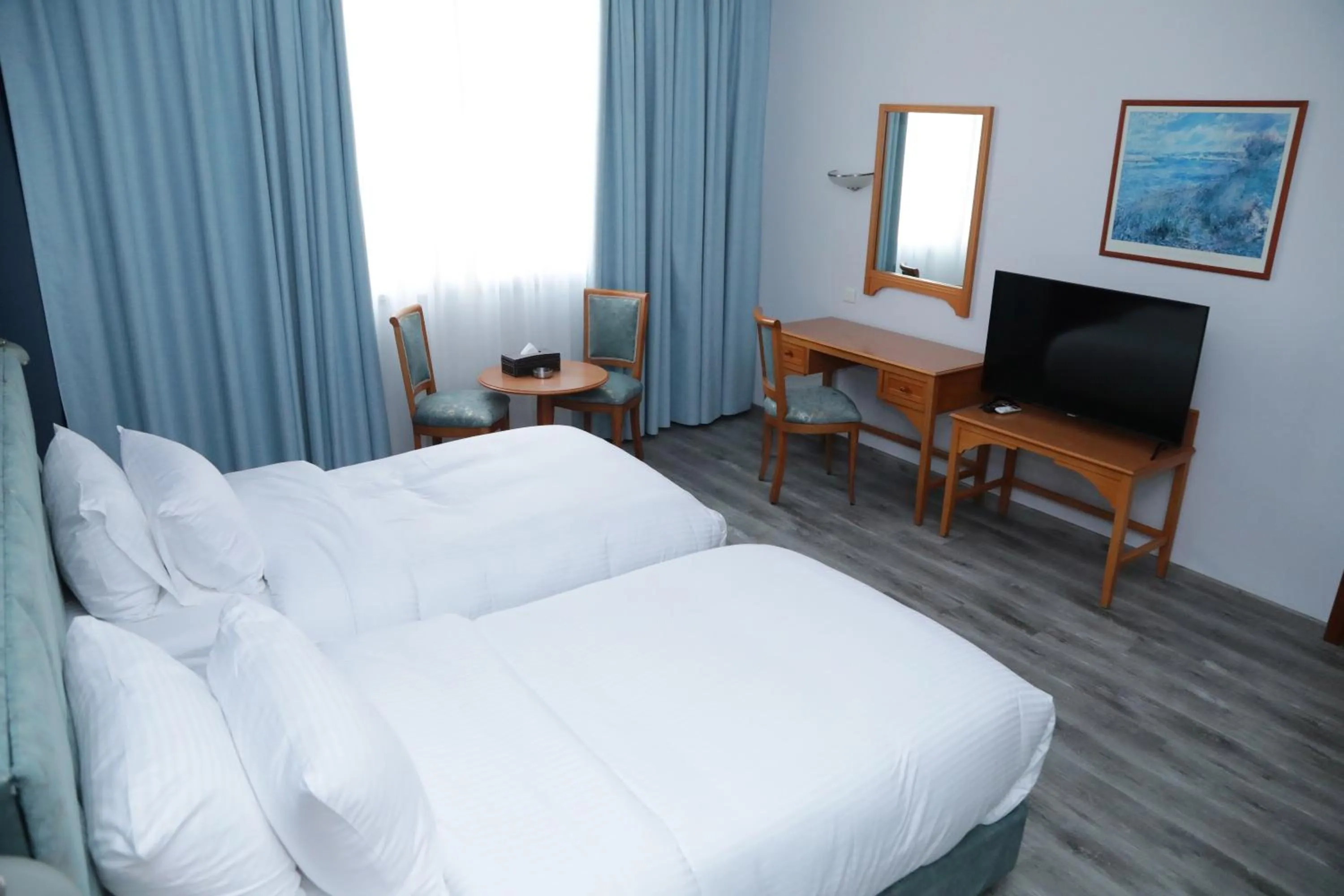 Communal lounge/ TV room, Bed in El Sheikh Suites Hotel