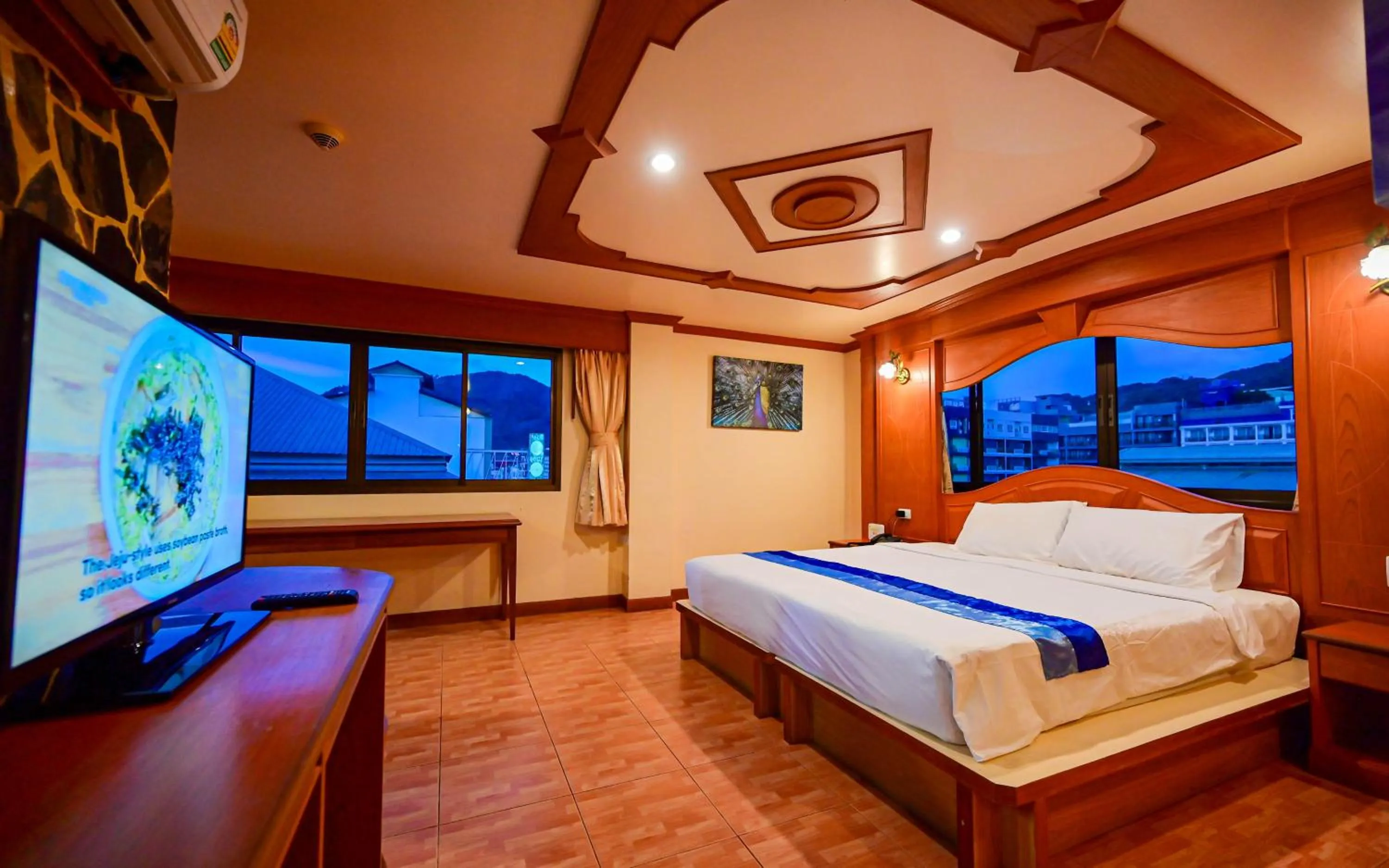 Communal lounge/ TV room, Bed in Tiger Complex Hotel