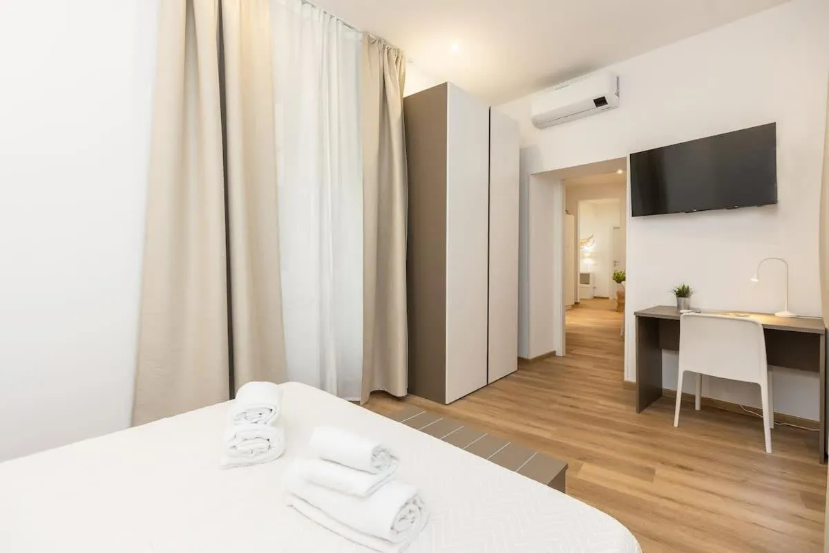 Bed in Colosseum Holidays - Three-Bedroom Apartment