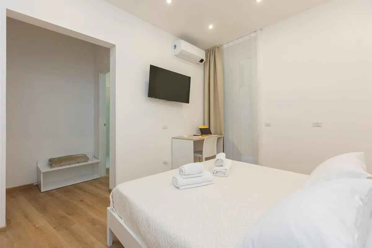 Bed in Colosseum Holidays - Three-Bedroom Apartment